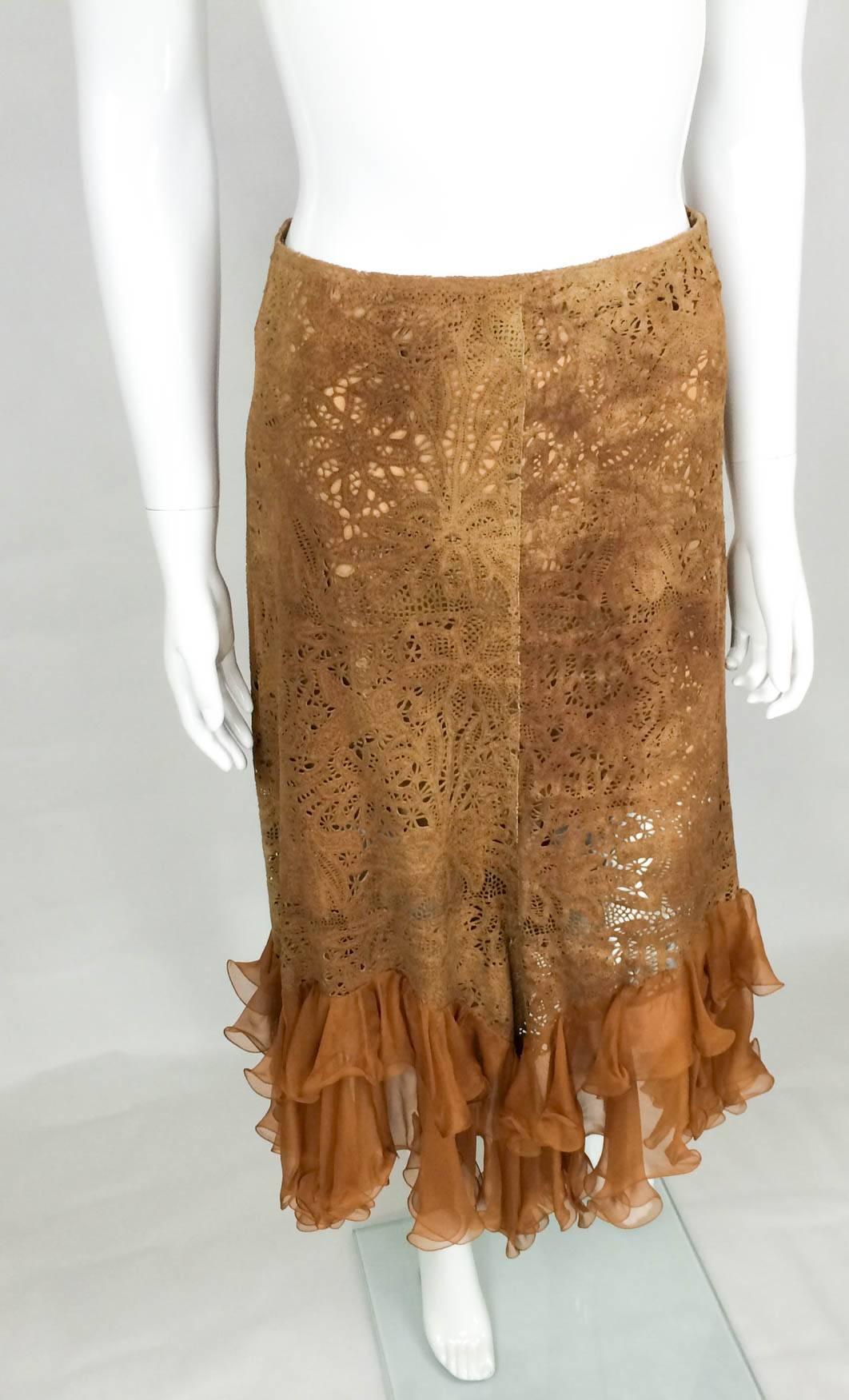 Fabulous Emanuel Ungaro Suede Lace and Silk Ruffles Skirt. This one of a kind skirt features an intricate work on lamb suede emulating lace and two tiers of silk ruffles at the bottom. High-waisted, this piece flares out to uneven hemline. The