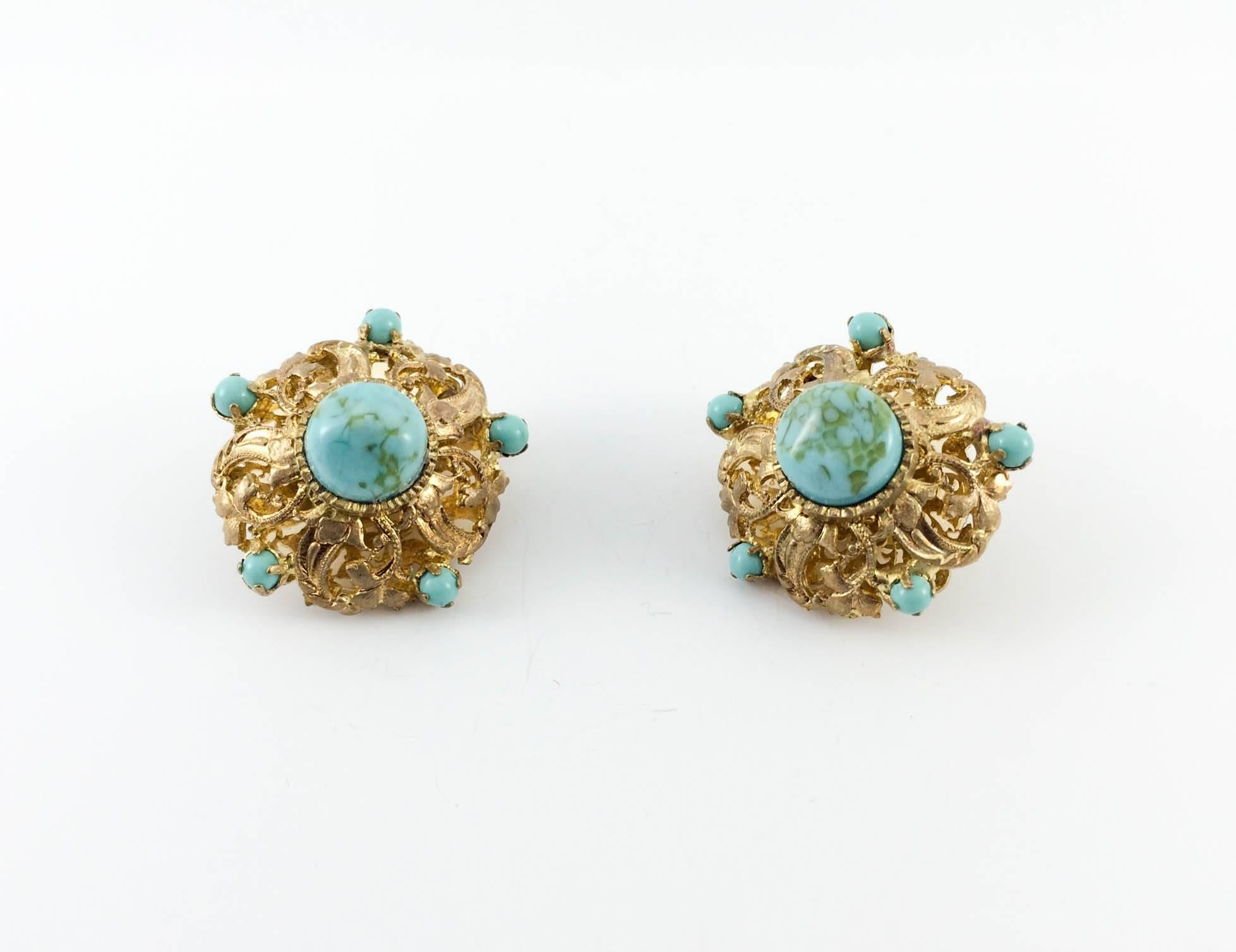 Important Chanel Gripoix Clip-on Earrings. These stunning earrings date back from the 1950s. They feature blue gripoix emulating turquoise and intricate work on gilt metal. Chanel signed. Part of the Chanel costume jewellery line, they were made by
