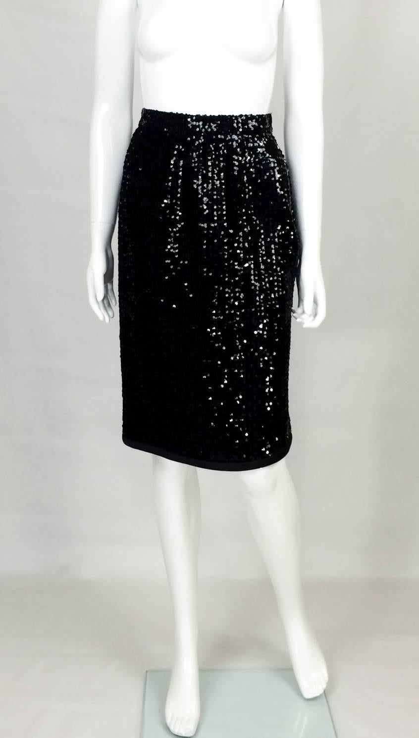 Gorgeous Vintage Yves Saint Laurent Sequin Skirt. This beautiful Yves Saint Laurent black skirt is made of beautiful small sequins and is fully lined. This knee-length, A-line shaped, high-waist skirt also features a satin hemline. Invisible side