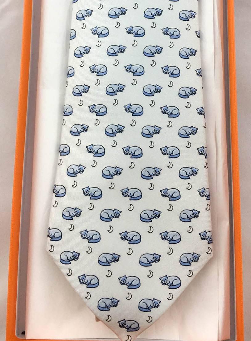 Stylish Hermes Silk Tie. Made in pure silk, this numbered print (5415 OA) in shades of light blue features sleeping cats on the front and dancing mice on the narrow end of the tie. This is a classy way to some fun to a suit. A quirky and elegant bit