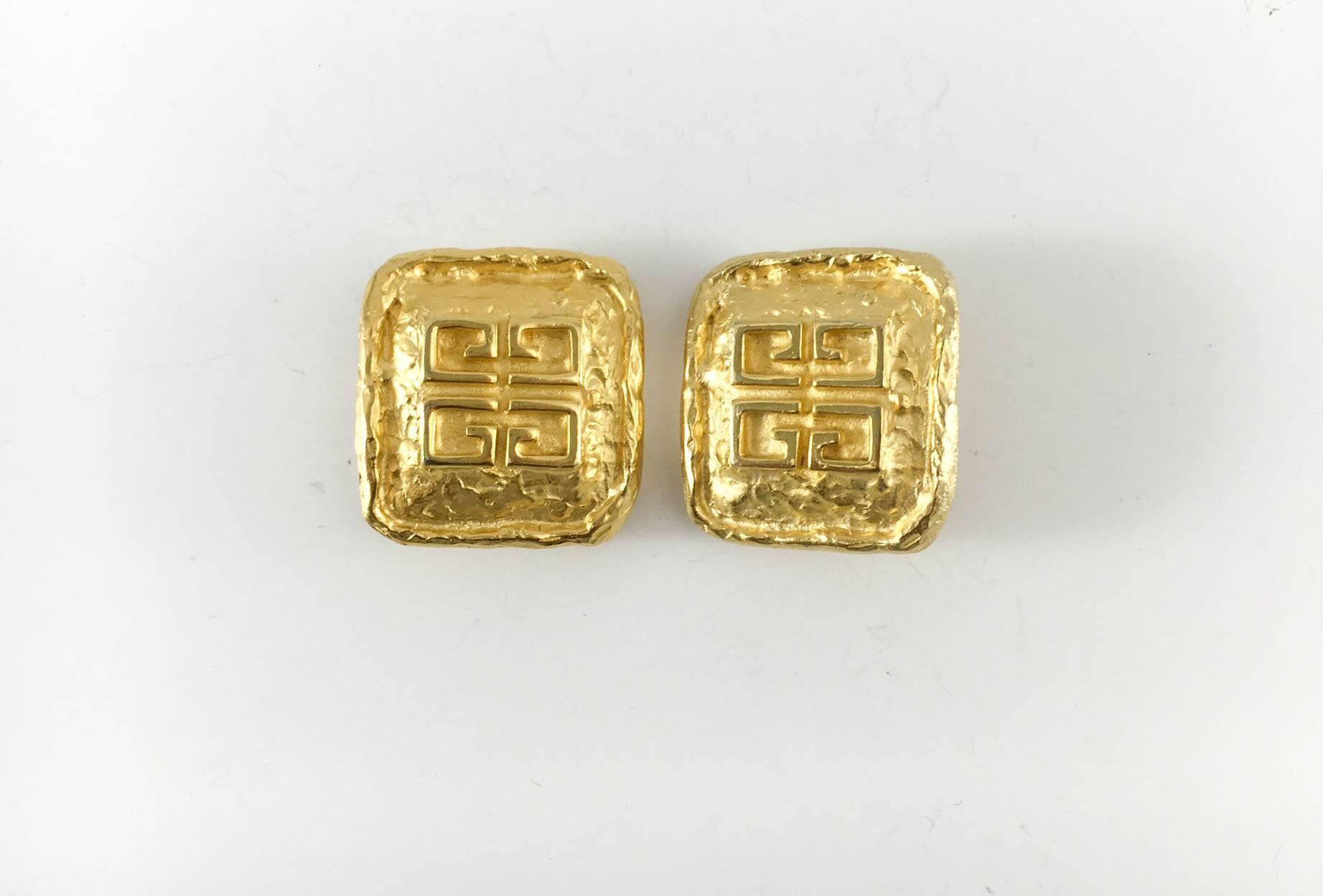 Vintage Givenchy Gold-Plated Clip-on Earrings. These very stylish pair of gold-plated Givenchy earrings feature the Givenchy logo and beautiful organic, melted gold texture. Signed Parfums of Givenchy France. The design is characteristic of iconic