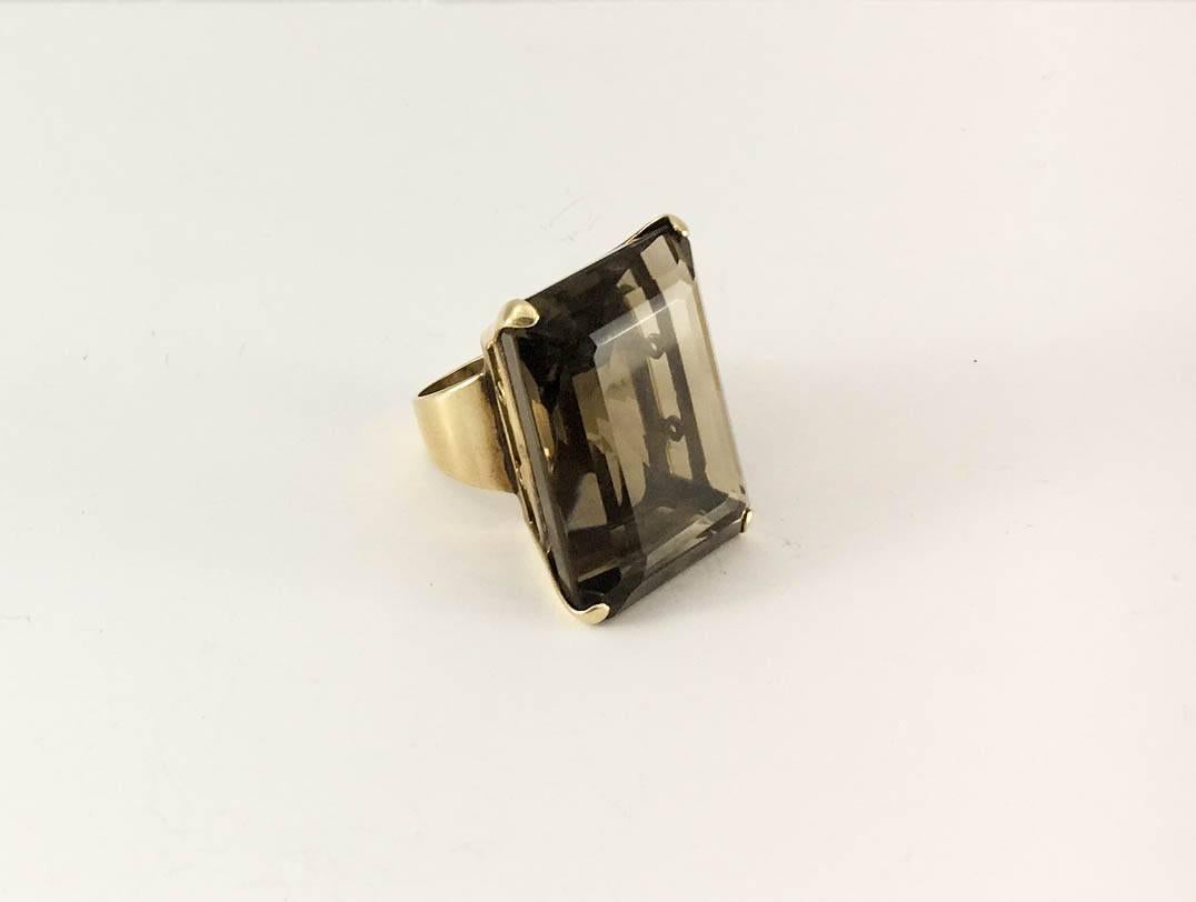 Vintage Smoky Quartz and Gold Ring. This fabulous piece from the 1960s and continental Europe features a huge rectangular piece of smoky quartz and is set on 18ct gold. Bold and elegant, this statement ring is certain show-stopper.

Period: