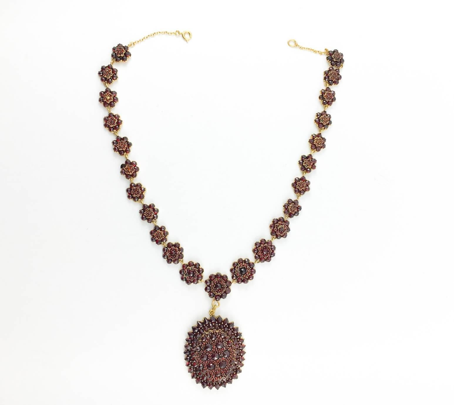 Antique Garnet Necklace. This beautiful piece of jewellery dating from the 1900s features a stunning and elaborate design in garnets. The stones have a gorgeous deep red tone to them. Great example of early 20th century Hungarian jewellery.

