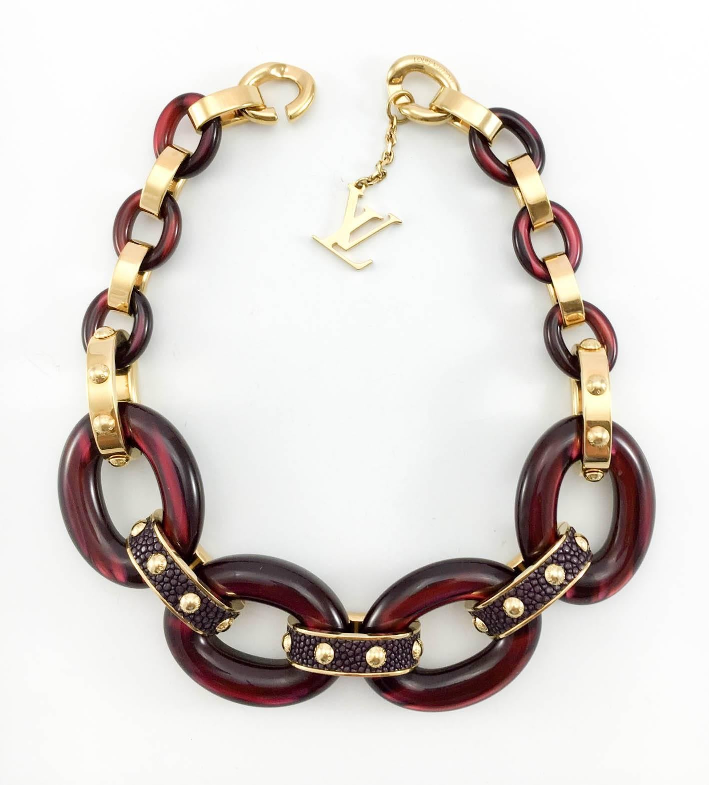 Gorgeous Louis Vuitton Necklace. This stunning piece is from the ‘Gimme a Clue’ line, which is characterised by luxurious materials, graphic shapes and studs that draw inspiration from trunk nails. The studs say Louis Vuitton, it is signed on the