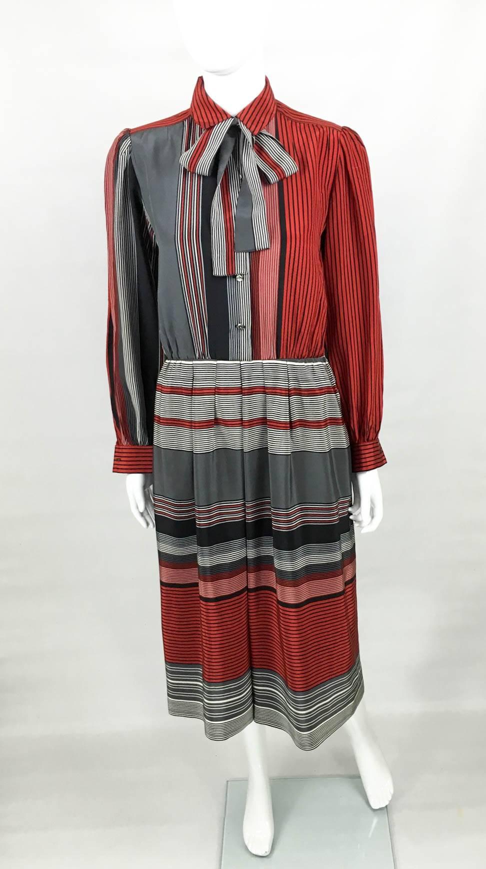 Vintage Balenciaga Silk Stripy Dress. This gorgeous silk dress by Balenciaga features stripes in red, grey, black and white. The top part of the dress has vertical stripes and the long sleeves, collar and buttons resemble a shirt. It comes with an