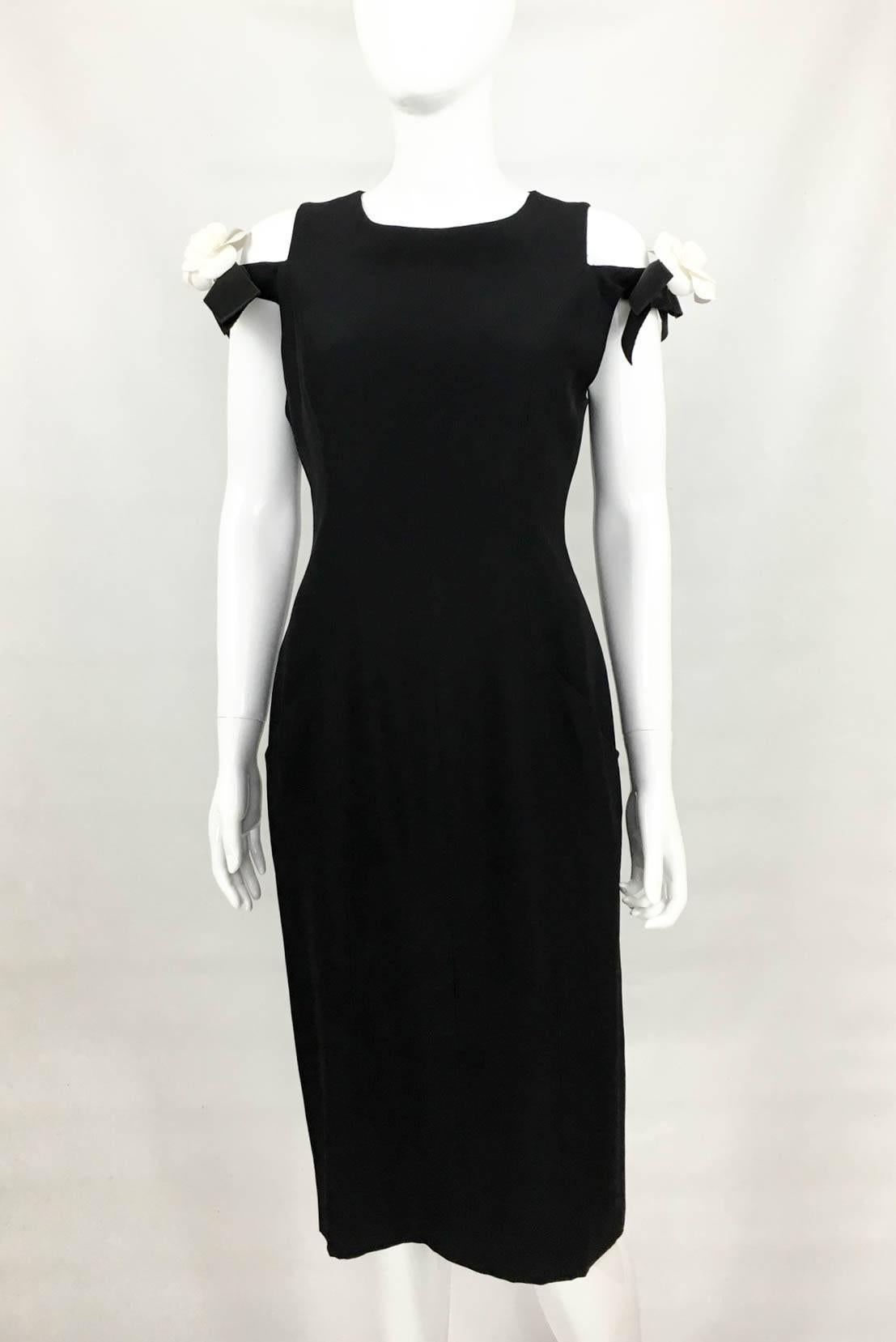 Chanel Black Silk Dress With Detachable Silk Camellias - 1990s

Vintage Chanel Silk Black Dress With Detachable Silk Camellias. Absolutely fabulous little black dress by Chanel. Made in Silk Crepe, it features bows off the shoulders on either