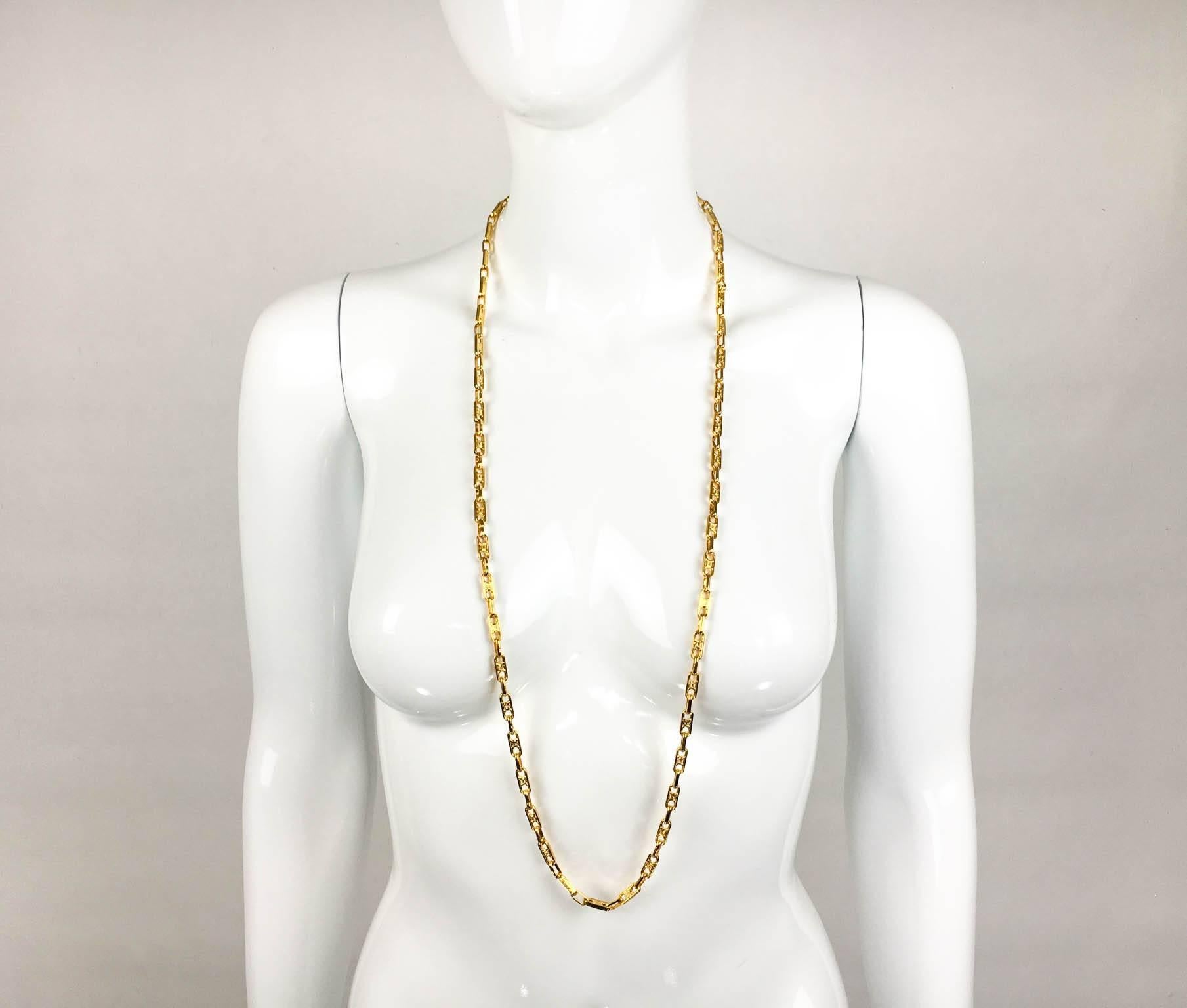 Vintage Celine gold-tone chain. This is a rather long Celine chain from the 1990s. The links are embellished by a delicate design. Celine signed on the clasp. This chain is very versatile, as it can be worn as one long chain or doubled up.

Label