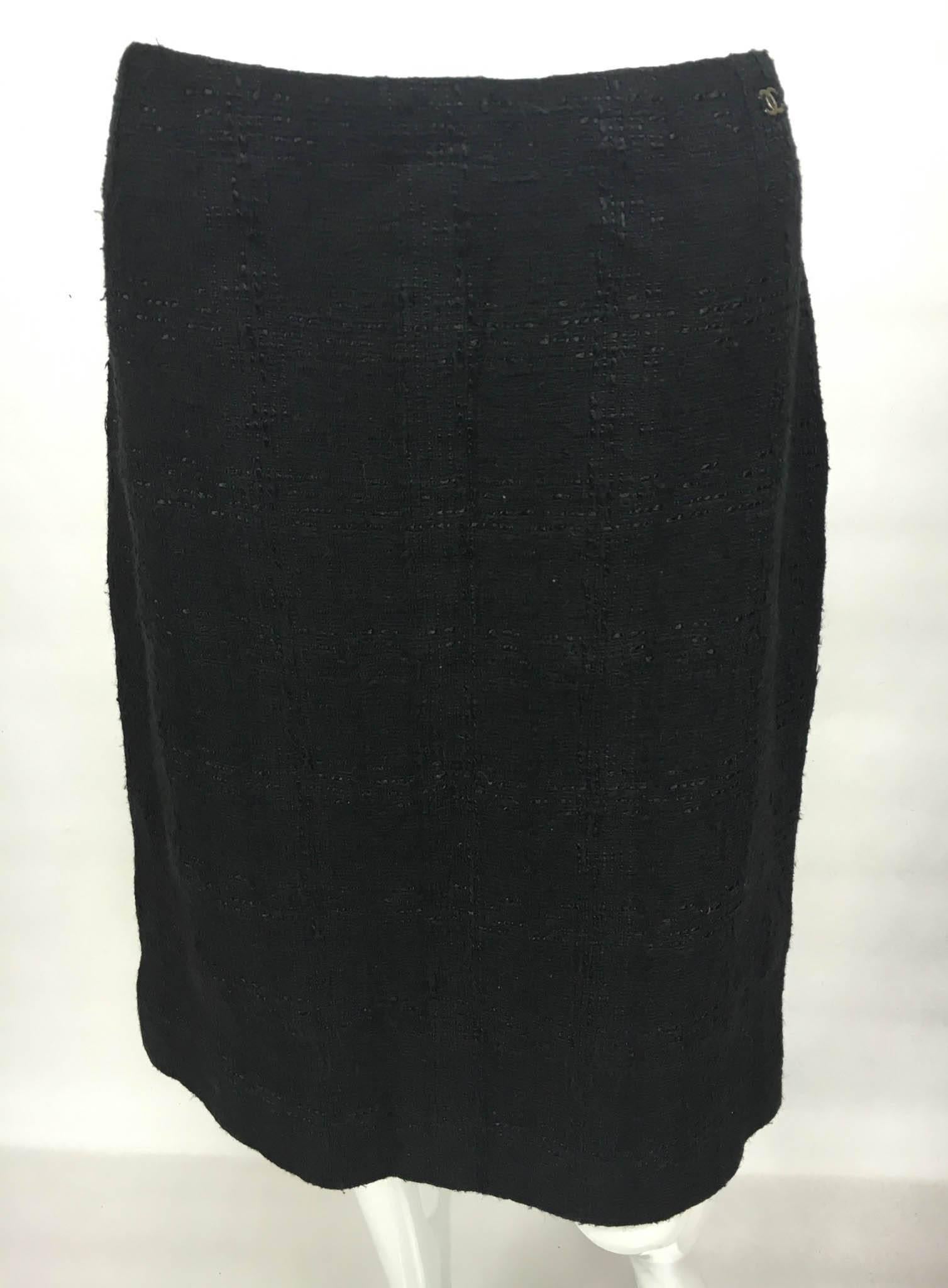 This stylish piece is a Chanel Black Boucle Skirt. Knee-length, it has a slit at the back. It features an invisible side zipper and the iconic Chanel ‘CC’ logo in metal at the waist. A bit of timeless class by Chanel.

Label / Designer: