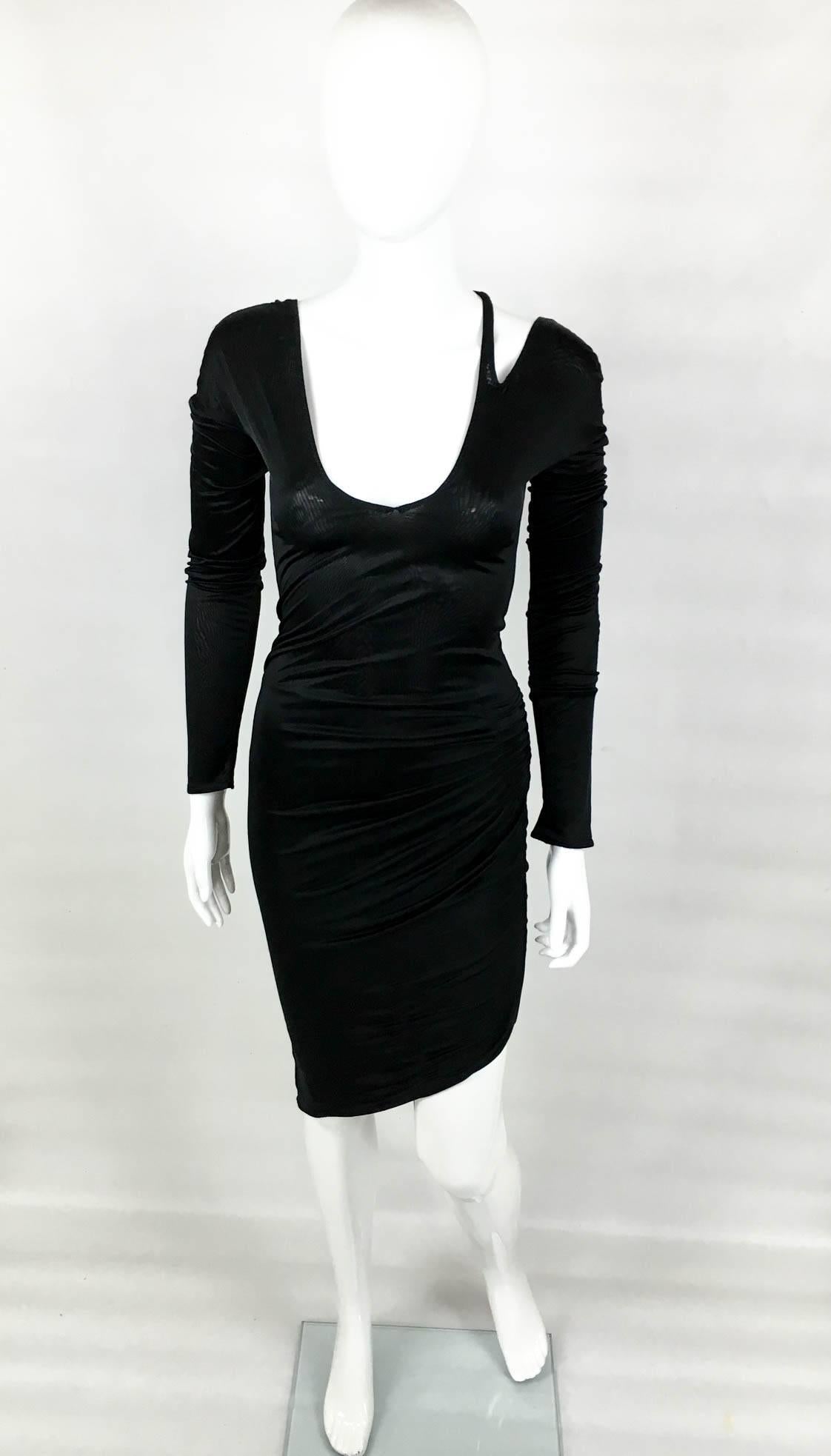 Vintage Gucci by Tom Ford asymmetrical long sleeve dress. This super sexy Gucci dress epitomises the Tom Ford’s reign in the fashion powerhouse – the chic femme fatalle. The neckline is low, front and back, and it features a strap detail connecting
