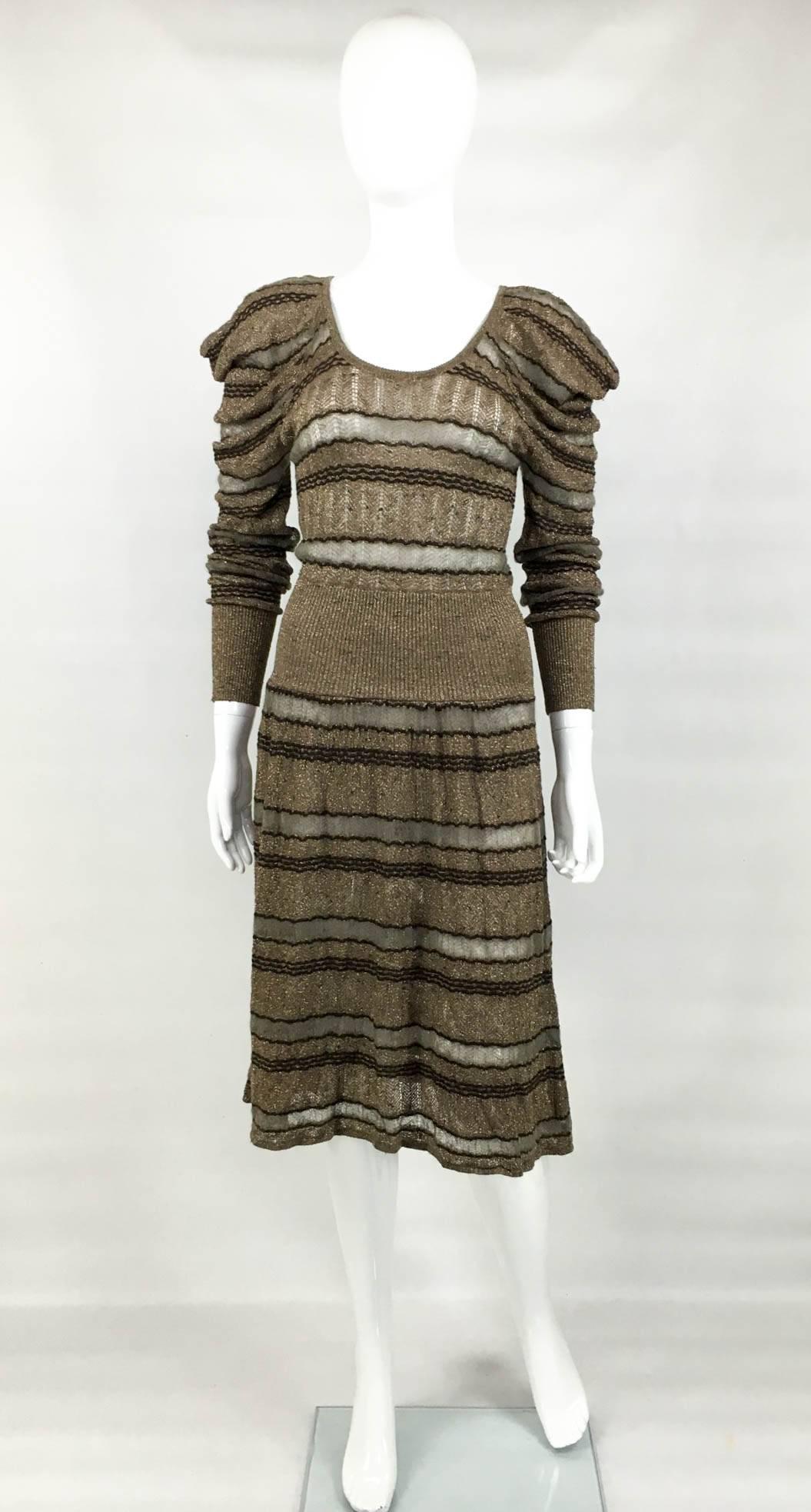 Vintage Kenzo Lurex Knitted Long Sleeve Dress. This striking dress by Kenzo features exaggerated shoulders and scoop neckline. In stripes, the knit is somewhat sheer, with the light grey stripe being the sheerest. The cuffs and the waist band are