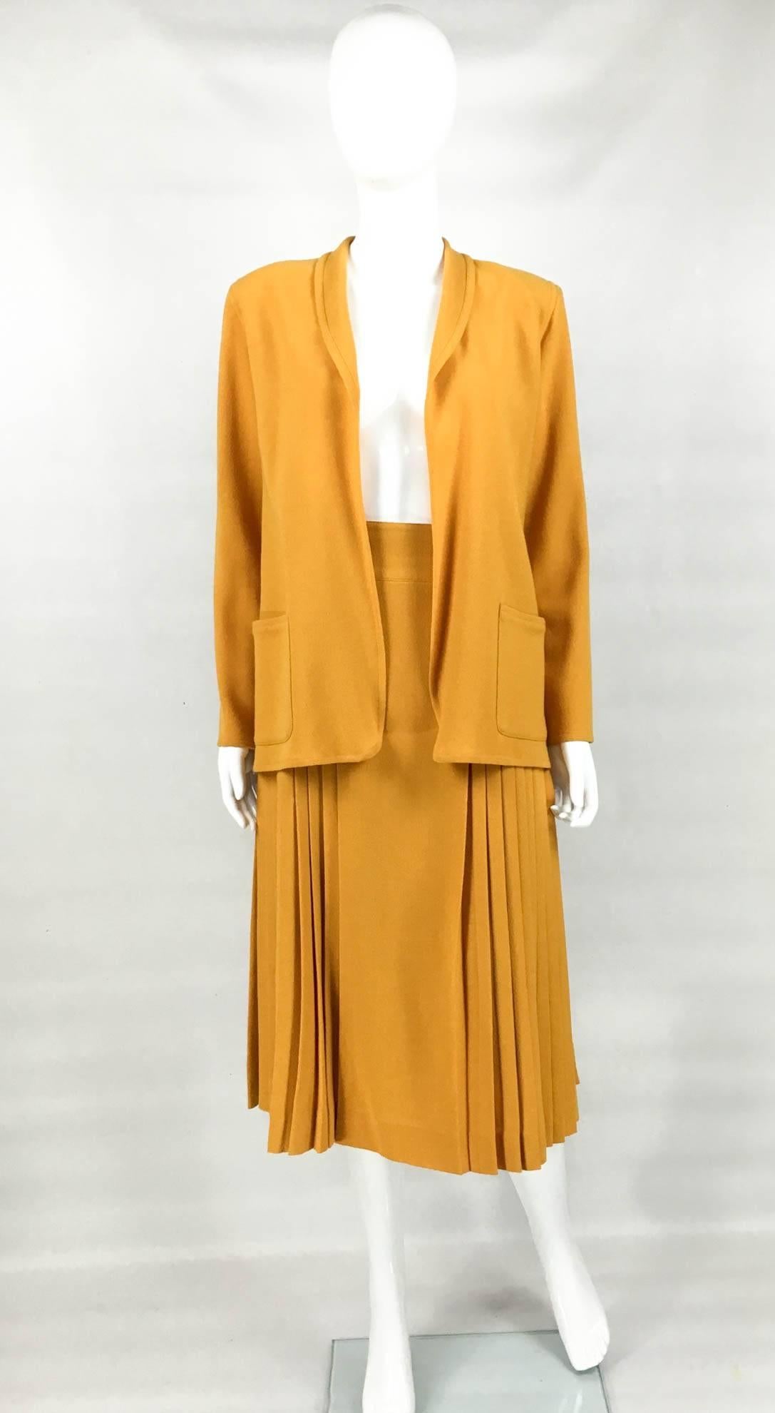 Gorgeous and Rare Vintage Christian Dior Tricots and Coordonnes Wool Crepe Mustard Suit. This fabulous mustard orange ensemble by Dior inspired by the 1940s dates back from the 1970s. With a high waist, the below the knee fully-lined pleated skirt