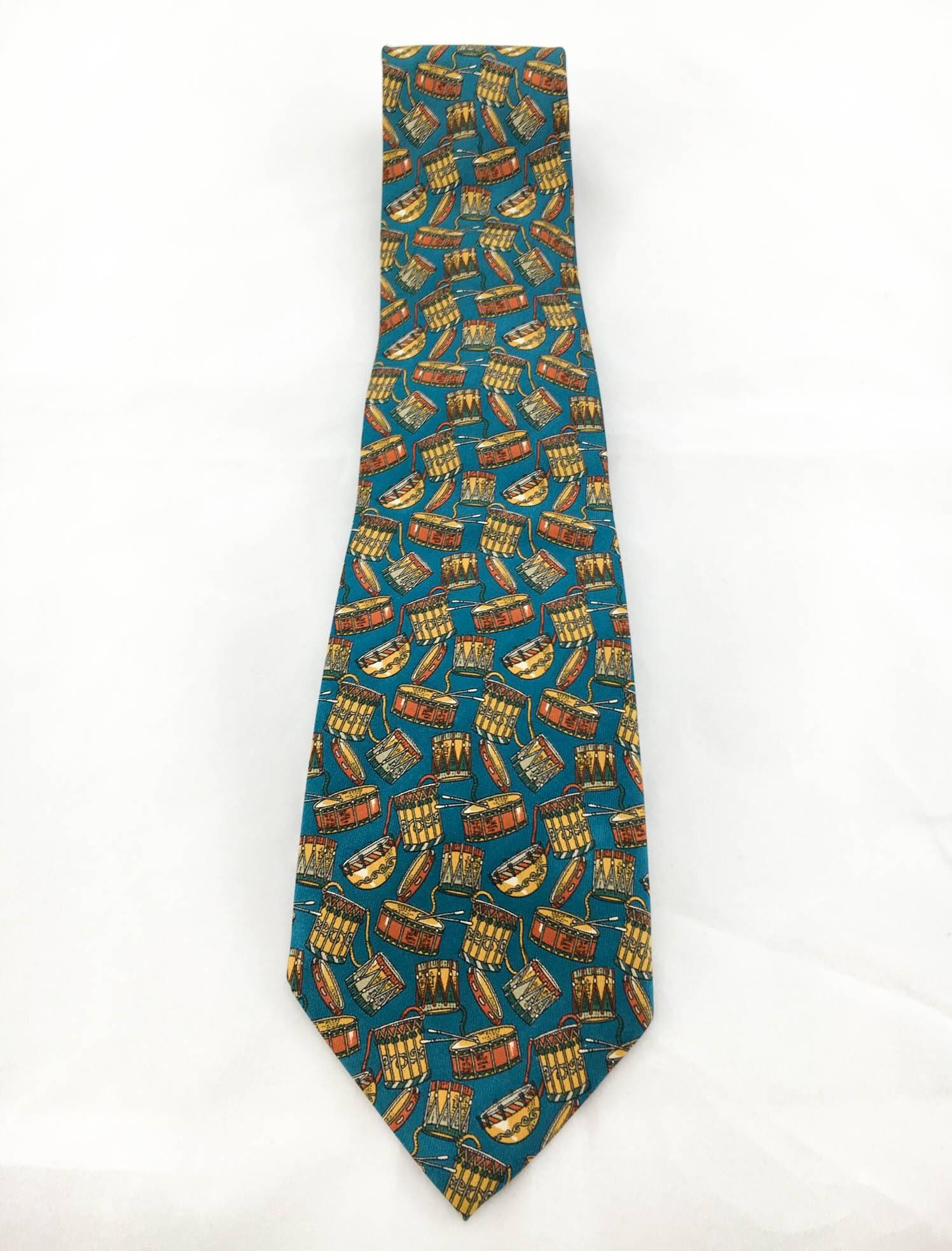 Classy Salvatore Ferragamo ‘Drums’ Silk Tie. This striking tie features various percussion instruments on a blue background. In pure silk, it would complement the look of music fans or just add a bit of fun without compromising on style. 

Label /