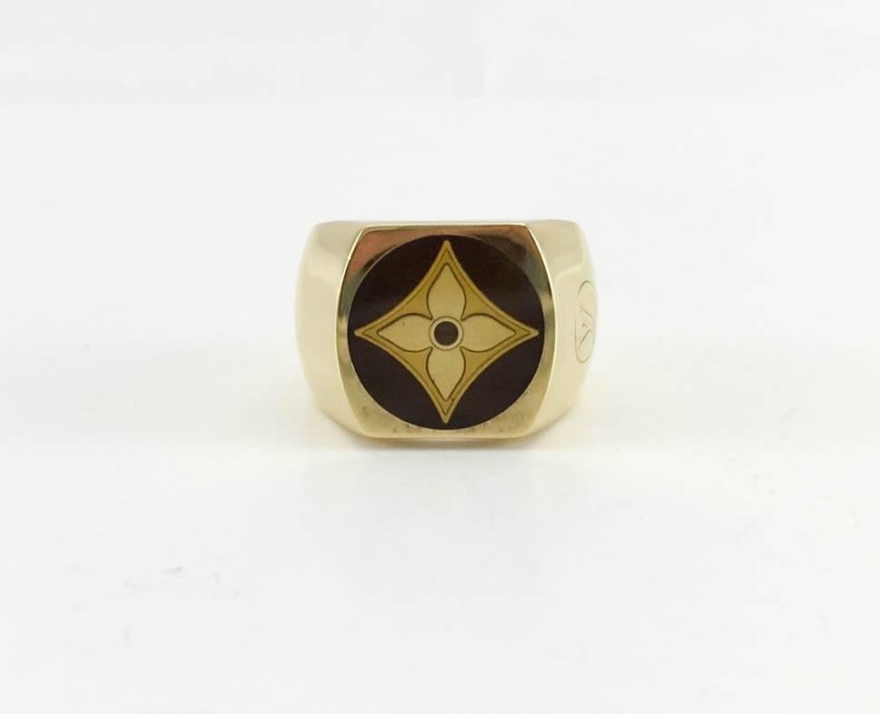 Ultra-Stylish Louis Vuitton Enamel and Gilt Silver Signet Ring. This gorgeous signet ring by Louis Vuitton features the iconic enameled flower monogram (fleur de monogramme) and the LV logo on one side. The ‘Fleur de Monogramme’ is in two different
