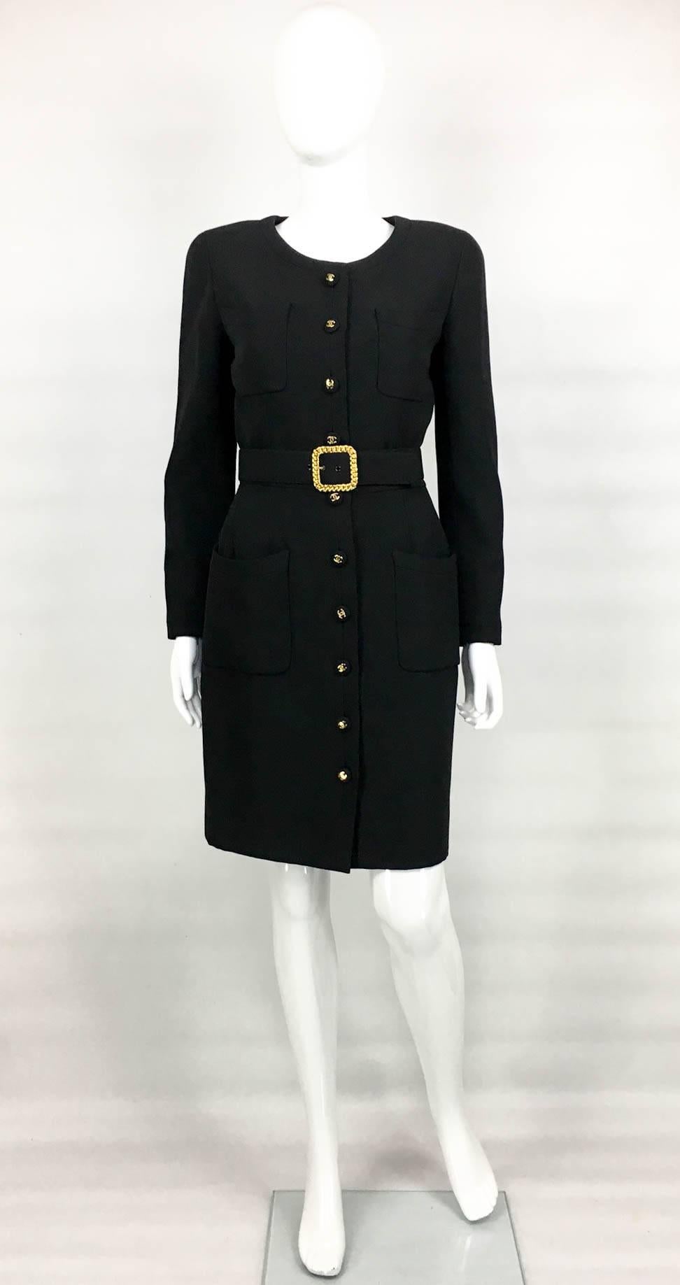 Chic Chanel Vintage Wool Gabardine Belted Black Dress. This stylish lightweight wool dress by Chanel dates from 1992 and features covered buttons with gilt ‘CC’ logos on top. With long sleeves and round neckline, it has 4 front pockets (2 on the