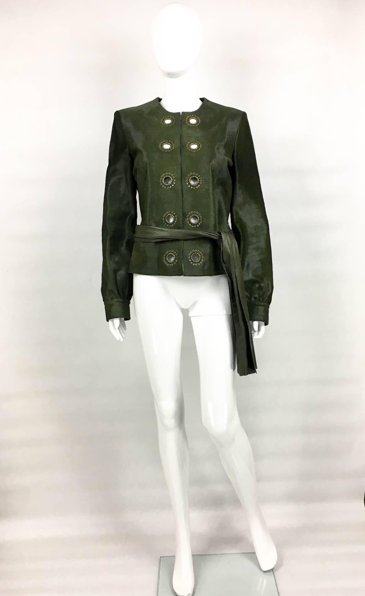 Gorgeous Yves Saint Laurent Moss Green Ponyskin Jacket. This fabulous unworn jacket by Saint Laurent is made of the best quality ponyskin / calf hair in moss green. It features brass eyelets down the front. The closure is done by hooks, which are