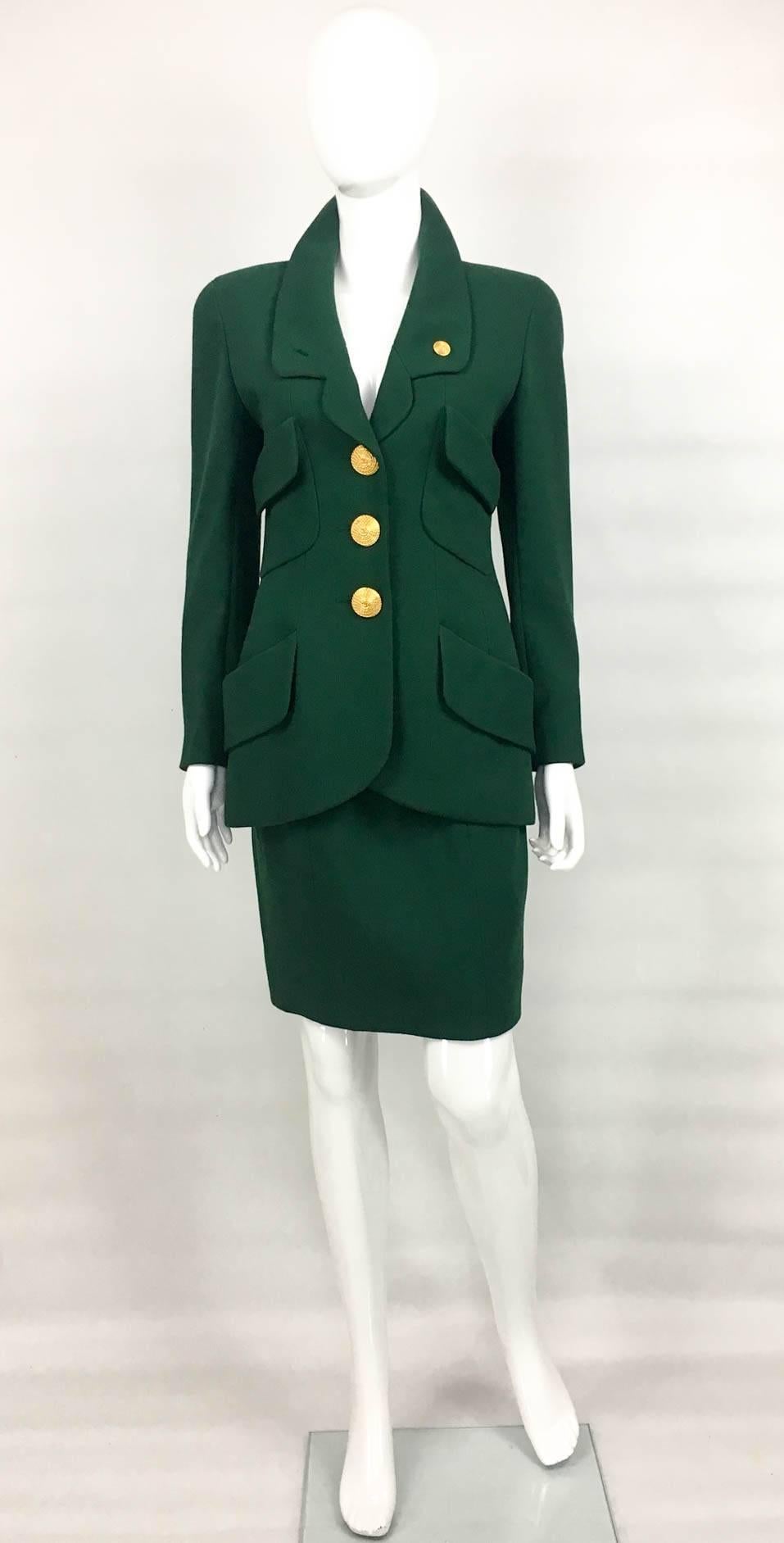 Super Stylish Vintage Chanel Green Suit. This amazing skirt suit by Chanel is made in bottle green wool and dates back from 1992. Impeccably tailored, with paneling and defined waist, it features four front flap pockets. The buttons are very special