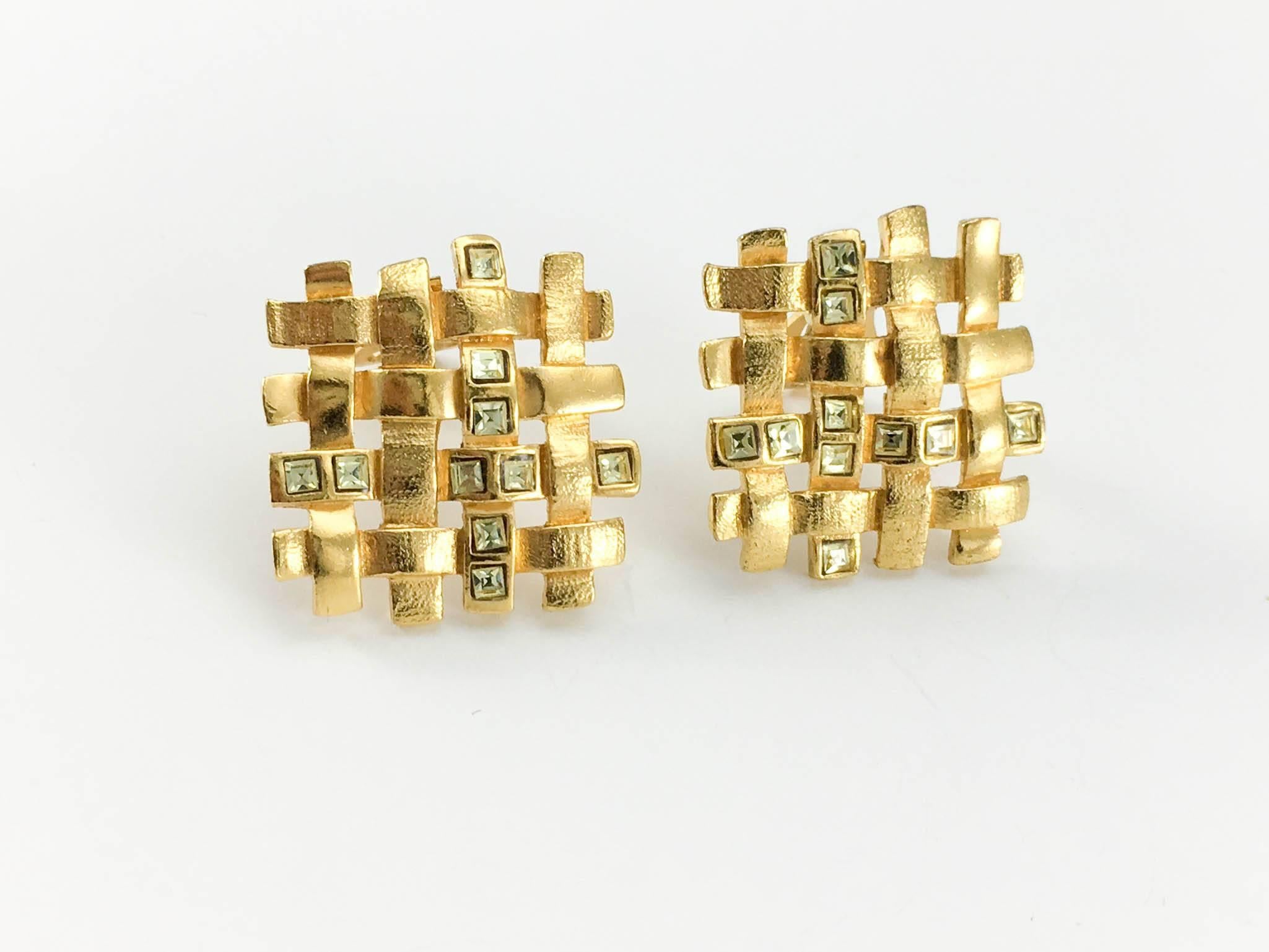 Vintage Yves Saint Laurent Gilt Clip-On Earrings with Crystals. These very pretty earrings by Yves Saint Laurent date back from the 1980's. In gilt base metal, the intricate design resembles woven fabric and features pale yellowy green paste /