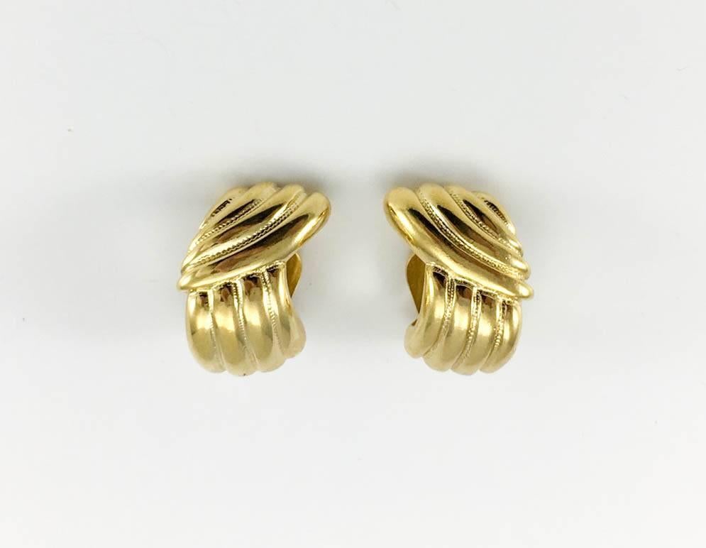 Vintage Yves Saint Laurent Gilt Clip-On Earrings. These stylish 1980’s earrings by Yves Saint Laurent are made in polished gilt base metal. The simple undulating design is classy and understated. They make the perfect addition to the fashion