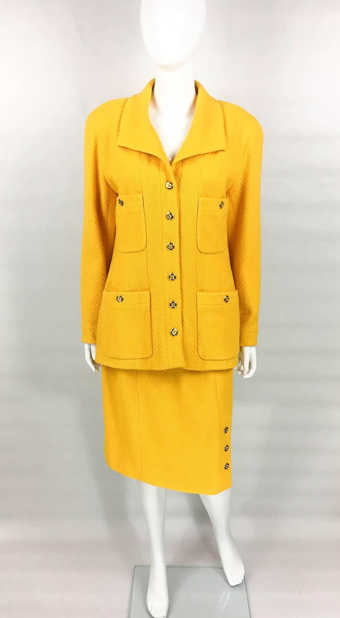Striking Vintage Chanel Wool Skirt Suit. This wonderful ensemble by Chanel dates back from the early 1980s. Made in a beautiful tone of golden yellow wool bouclé, this suit is certain to steal the spotlight. The jacket features four front pockets