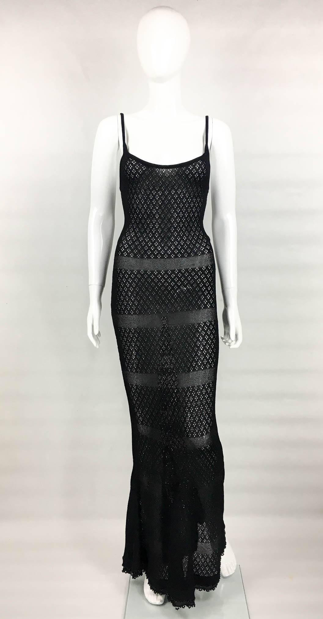 Important Chanel Knitted Sheer Maxi Dress. This fabulous piece for designed for the Spring/Summer 1995 collection. This figure hugging long dress is made of a cotton knit and lurex horizontal stripes. The bottom of the dress flares out, due to the