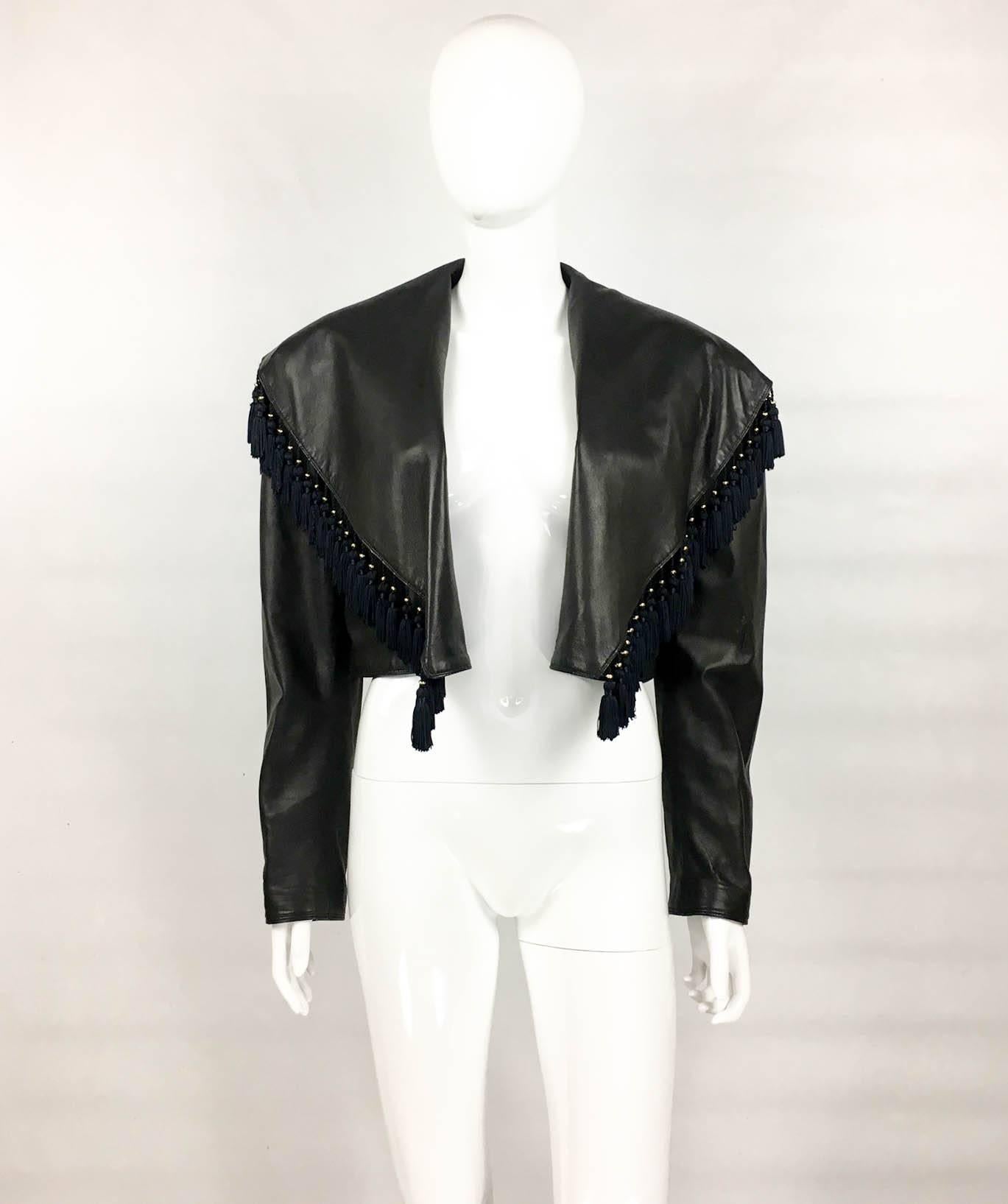 Vintage Gianni Versace Black Leather Jacket With Tassels. This fabulous piece by Versace dates back from the 1980s. Made in the softest black leather, it features a dramatic collar embellished with tassels. Open closure – which makes it very