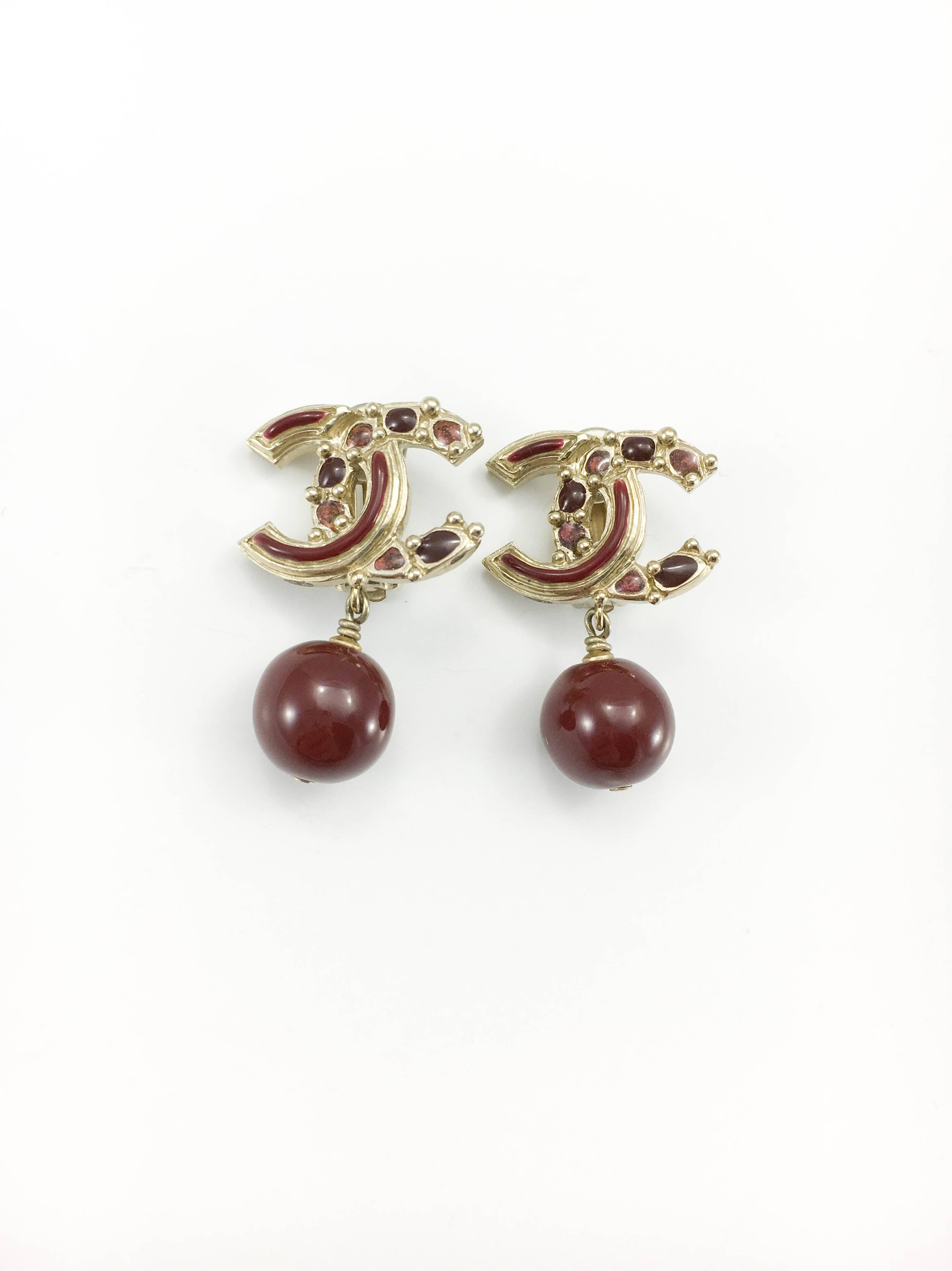 Gorgeous Chanel Red Gripoix Logo Earrings. These striking dangling clip-on earrings by Chanel are from the 2012, specifically from the Paris-Bombay Collection. In this collection, Karl Lagerfeld brought a poetic idea of India, a Parisian mixture of