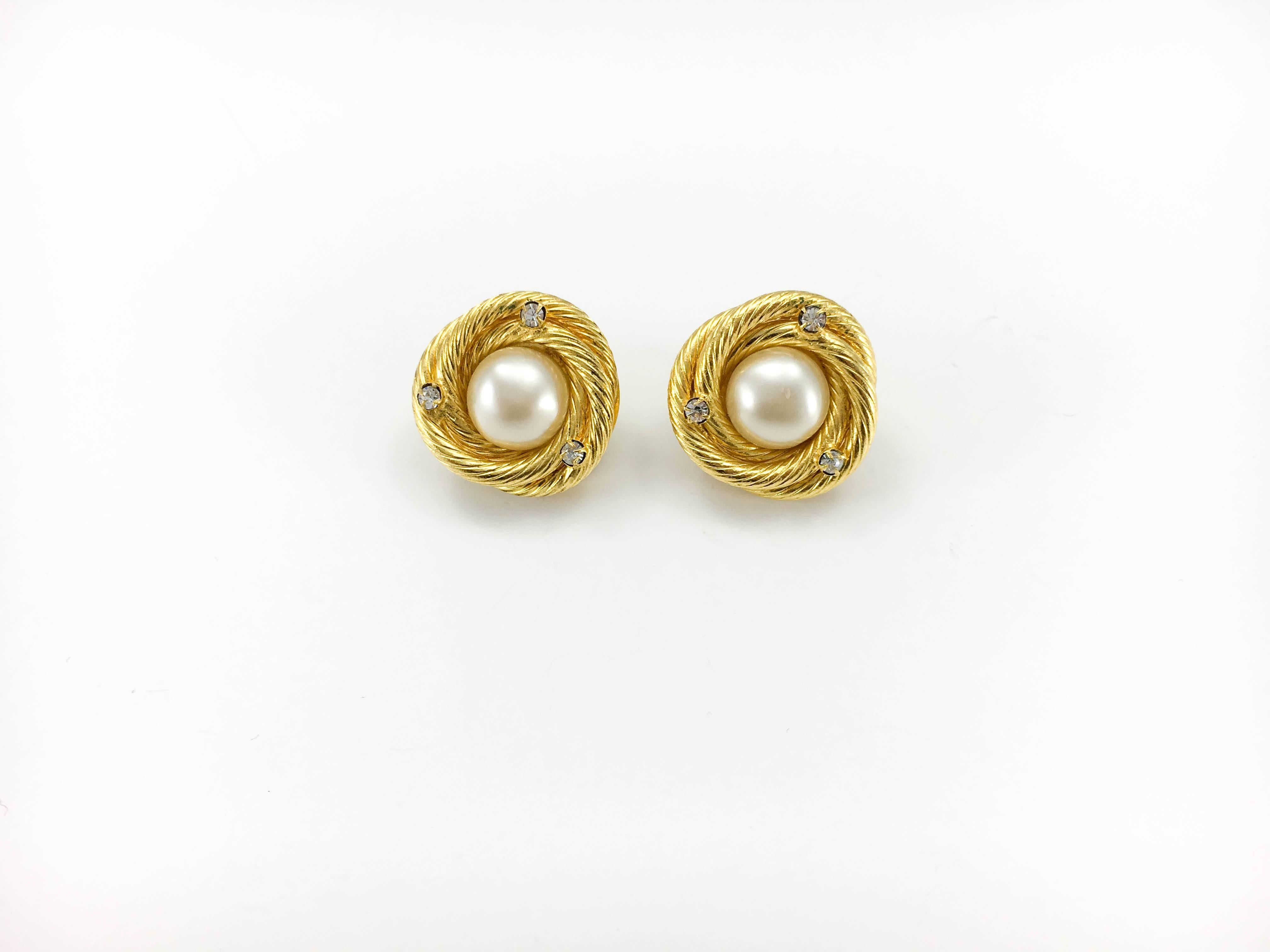 Vintage Chanel ‘Bird Nest’ Earrings. These stylish earrings by Chanel date back from 1993, Spring/Summer Collection. Made in gold-plated metal, they were made to look like a piece of rope that was rolled up to resemble a nest with a pearl cabochon