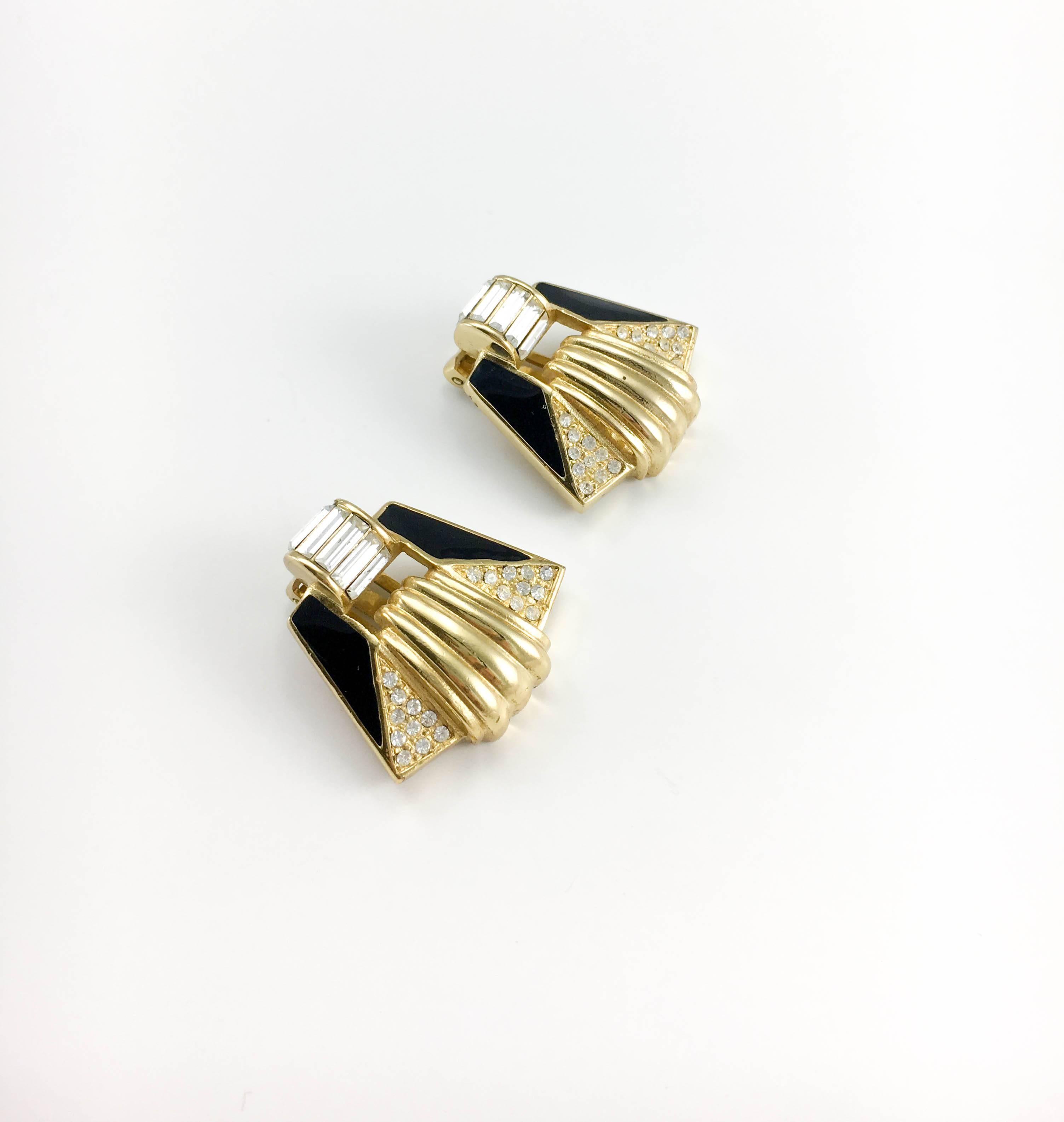 Striking Vintage Christian Dior Geometrical Clip-On Earrings. These fabulous 1980’s earrings by Dior are Art Deco-inspired. Gold-Plated, they feature geometric designs embellished with paste (rhinestone) and black enamel, as well as baguette-shaped