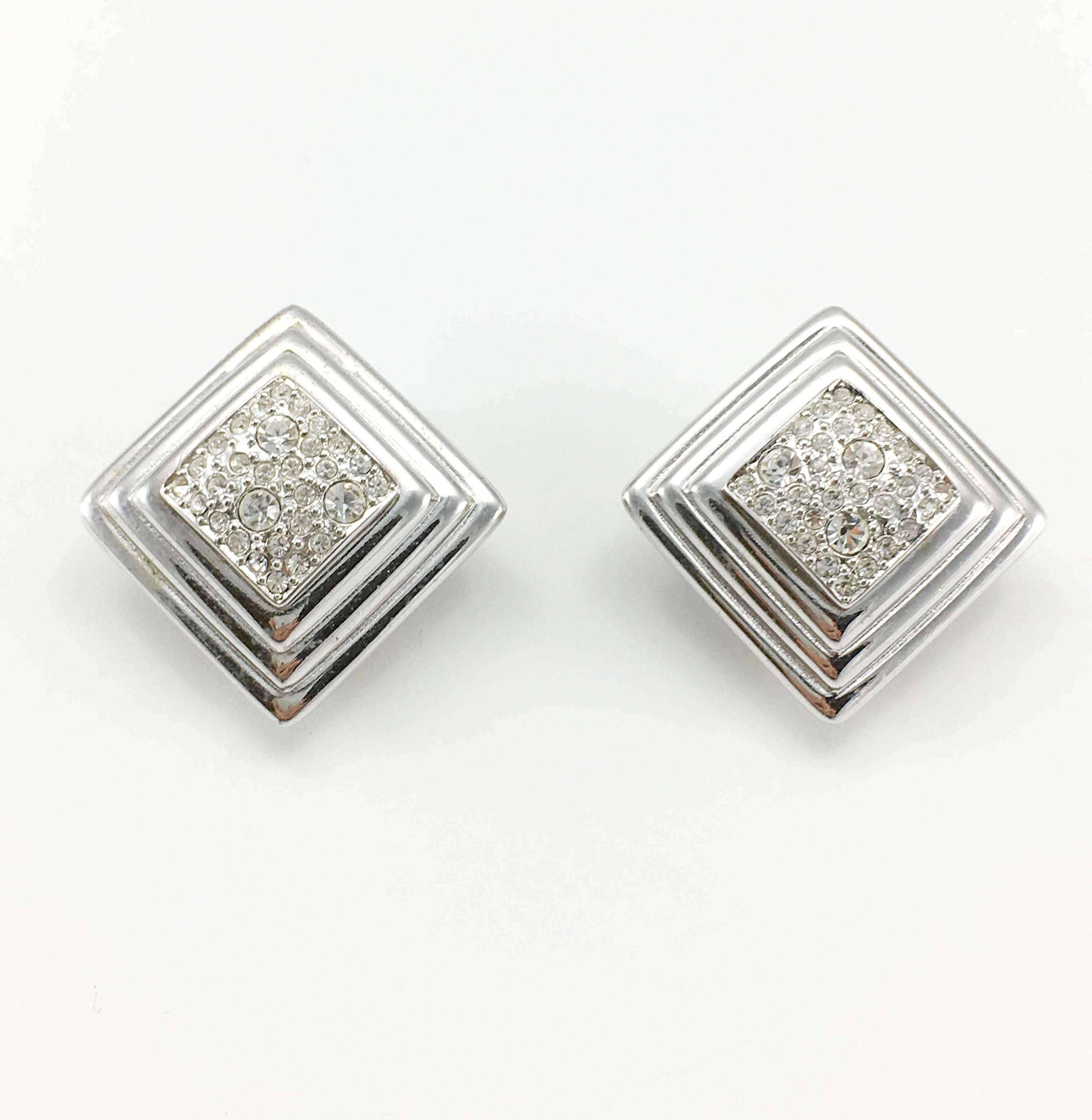 Vintage Dior Geometric Diamanté Clip-On Earrings. These striking 1980’s earrings by Dior are a perfect example of understated luxury. Art Deco inspired, the design consists of stepped lozenges (squares) with a paste/rhinestone encrusted centre.