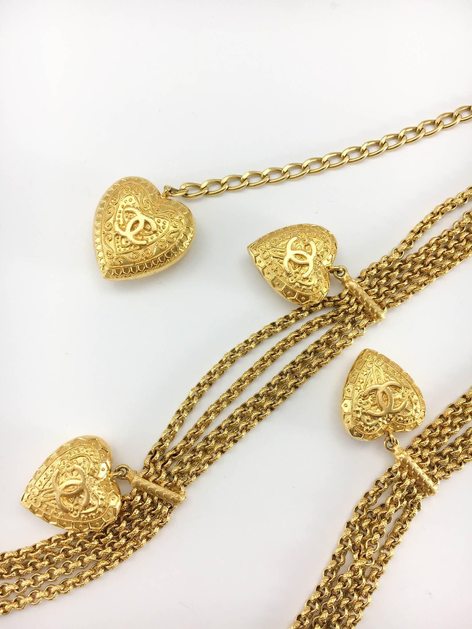 Rare Vintage Chanel Heart Belt / Necklace. This stunning piece by Chanel was created for the Fall/Winter 1996 collection. Versatile, this belt can be worn as a necklace. It is made of 4 strings of chain with 10 hearts distributed along it and a drop