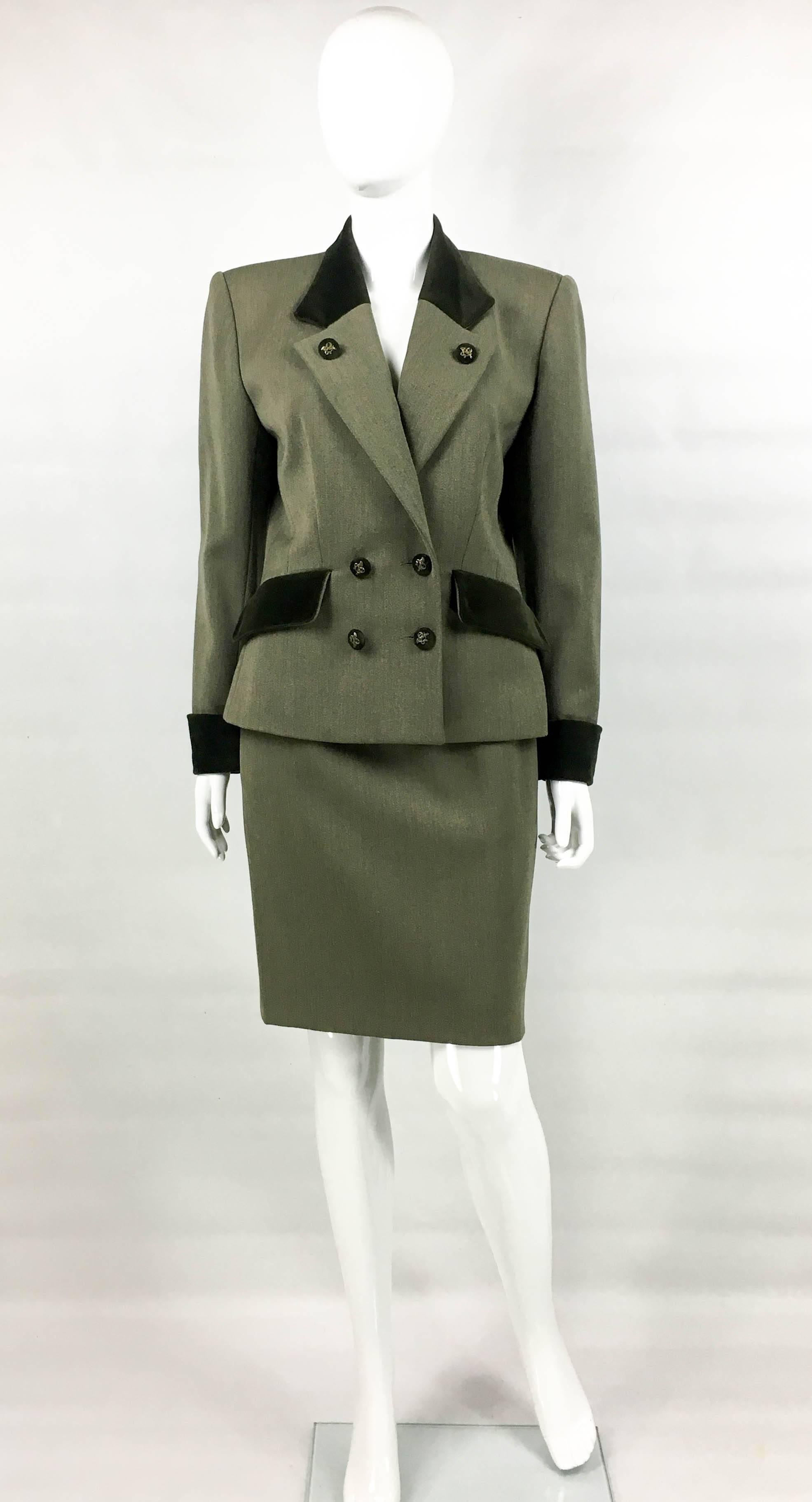 Super Stylish Vintage Hermes Skirt Suit. This very elegant ensemble by Hermes dates back from the 1980’s. Lovat, it is made in wool with velvet details on the collar, pocket flaps, cuffs and on the back. The jacket is double-breasted, with a defined