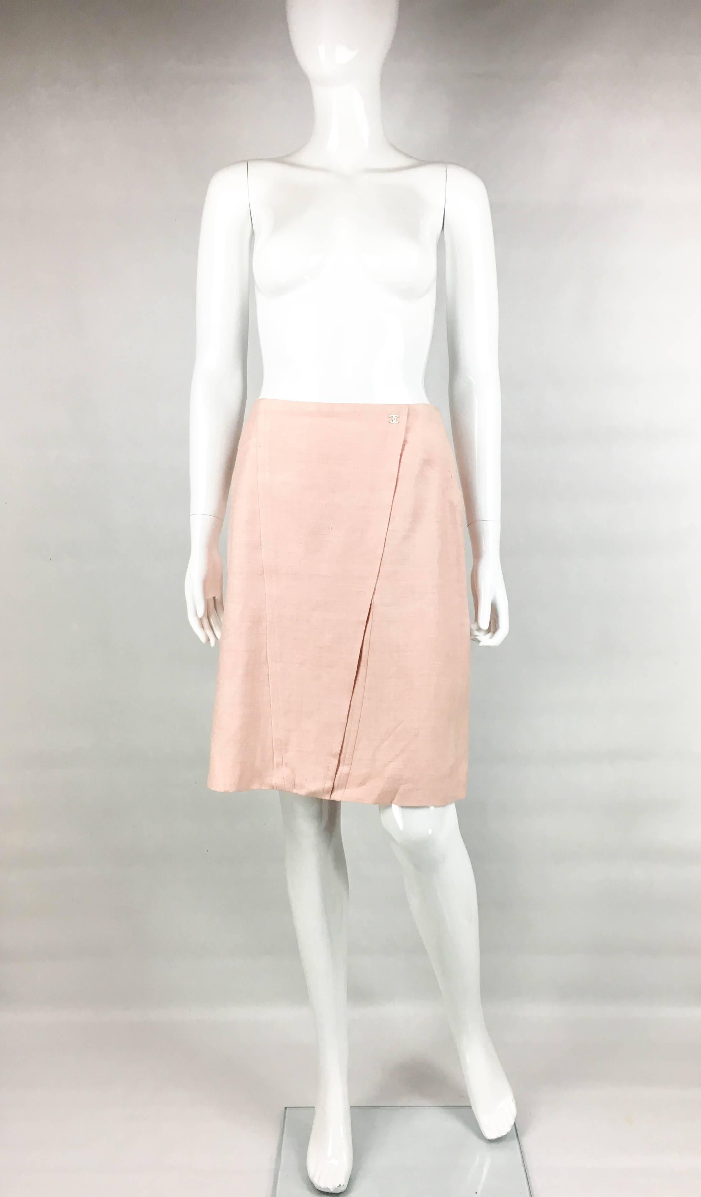 Stylish Chanel Pale Pink Silk Skirt. This very pretty slubbed silk skirt by Chanel is from the 2001 Cruise Collection. A-line shaped, it has a silver-tone ‘CC’ logo to one hip. Knee-length, the closure is by a hidden zipper on the back. A classy and