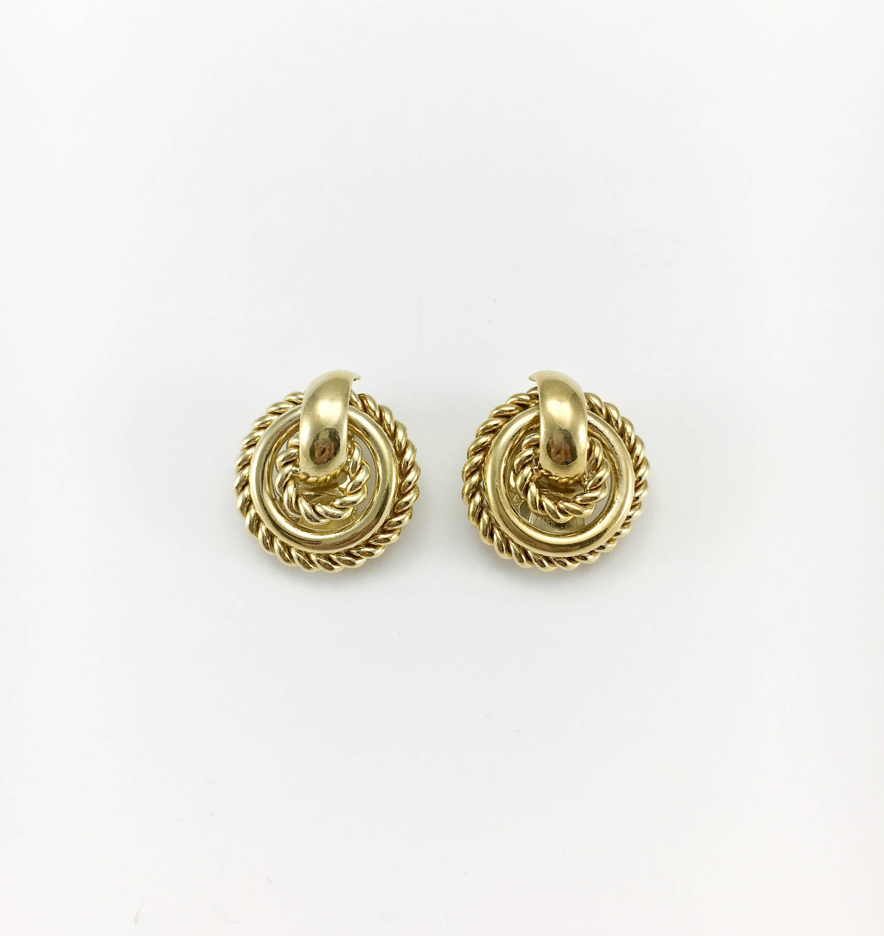 Stylish Vintage Christian Dior Clip-On Earrings. Made in Germany, they date back from the 1980’s. In gilt metal, the round design feature three rings, with the outer and inner ones resembling ropes. Ch Dior signed on the back. These earrings are an
