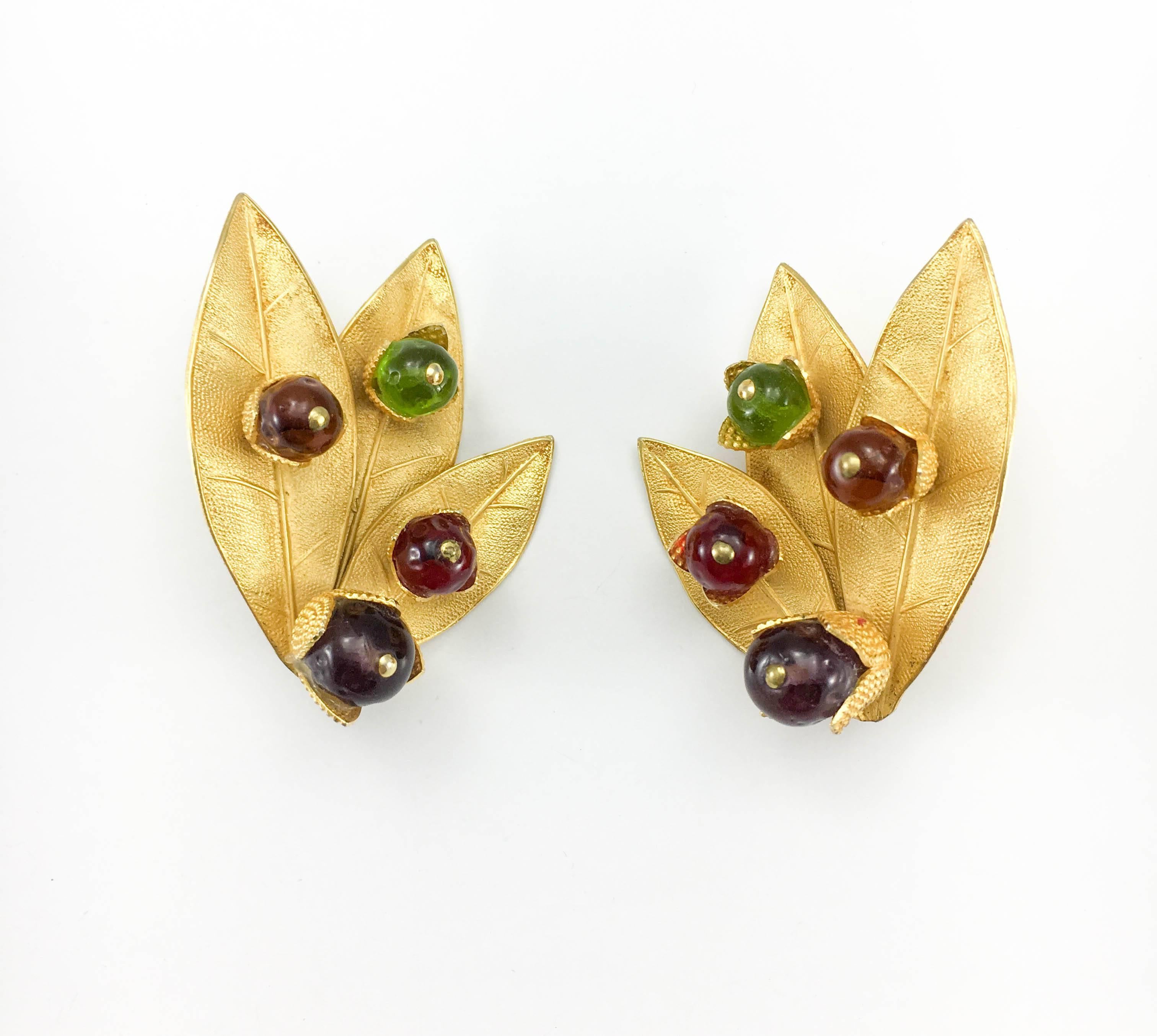 Striking Vintage Dominique Aurientis Leaf Clip-On Earrings. Made in the 1980’s, these earrings feature gilt hardware in the shape of very detailed three leaves adorned with four resin beads in purple, red, orange and green. The flamboyant design and