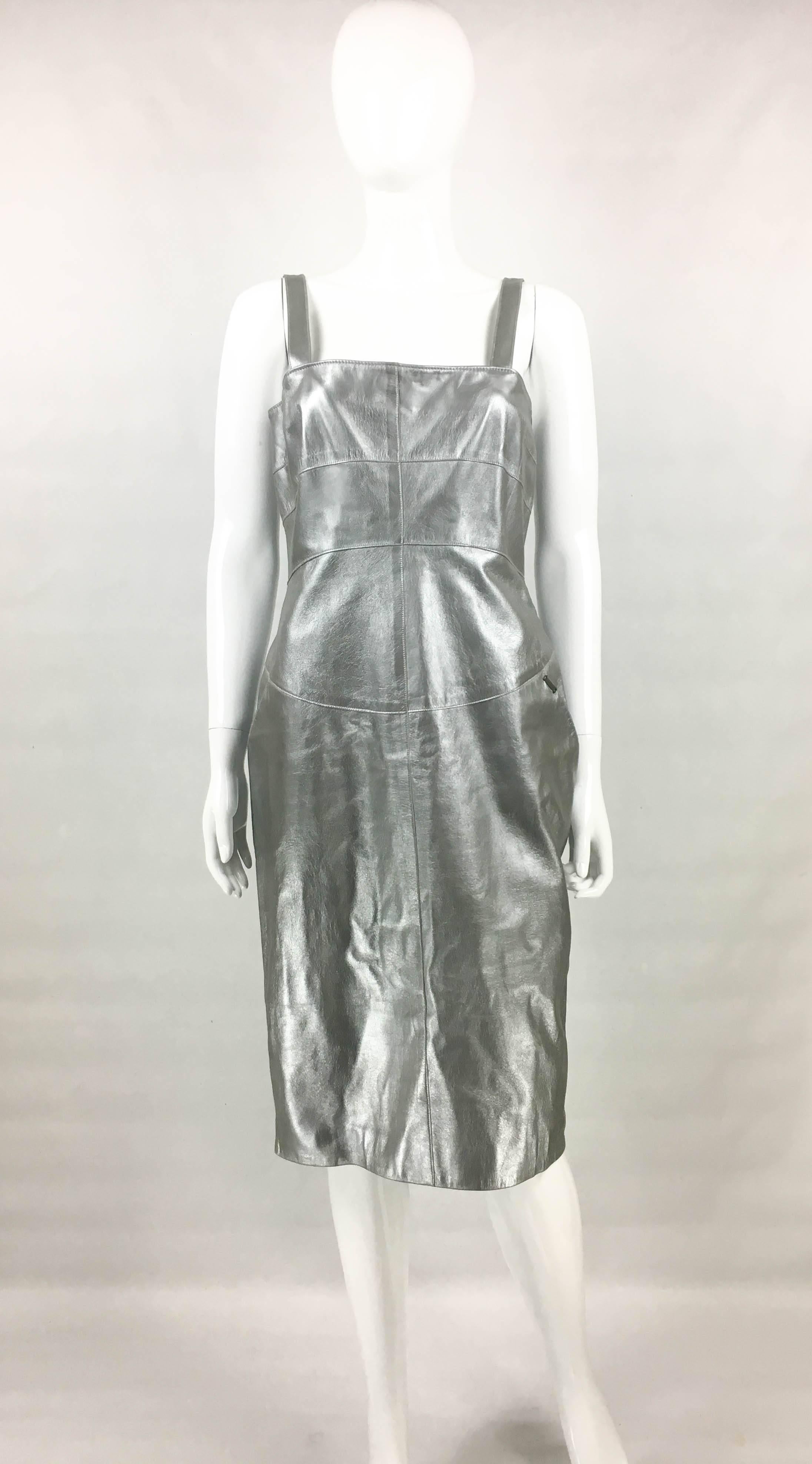 Vintage Chanel Runway Look Silver Leather Dress. This striking dress by Chanel was created for the 1999 Autumn Winter runway show – please refer to photos for a sister dress being worn on the runway. Crafted in silver lambskin, it has a futurist