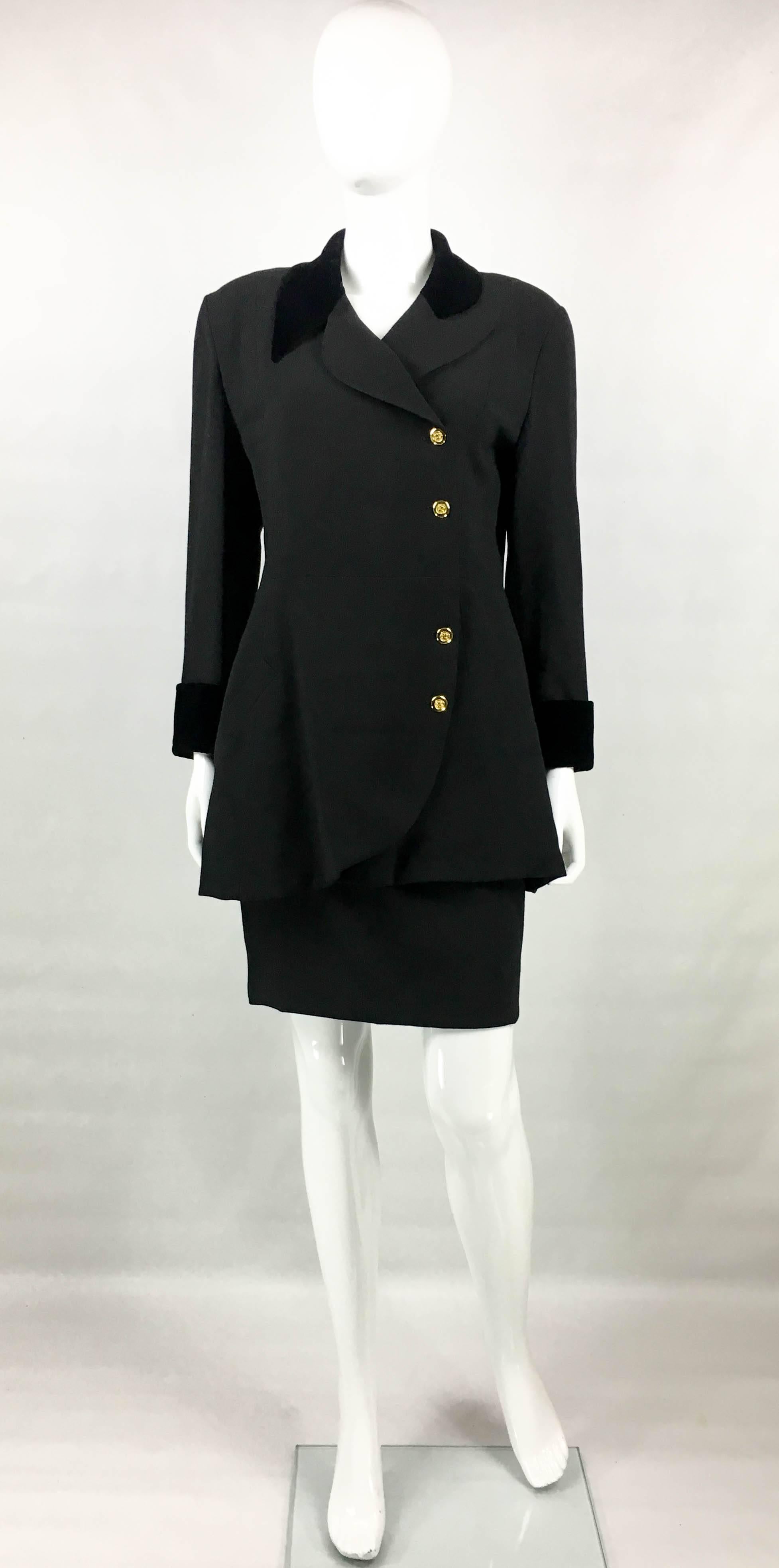 Vintage Chanel Black Wool Skirt Suit. This striking ensemble by Chanel dates back from the early 1990’s. Crafted in a light wool black fabric, it features black velvet collar and cuffs. The loose-fit design brings edgier elements as the asymmetric