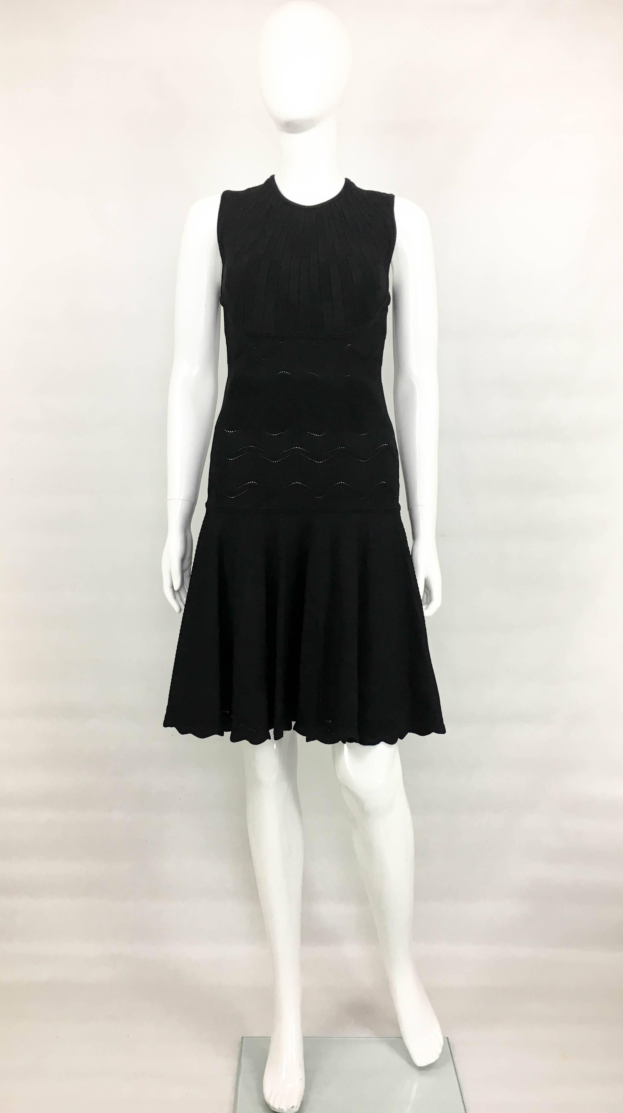 Alexander McQueen Black Cocktail Dress. This great sleeveless little black dress by Alexander McQueen has a lovely silhouette. Made in a stretchy viscose jersey, this body hugging dress has a drop waist and flaring short skirt. There are many