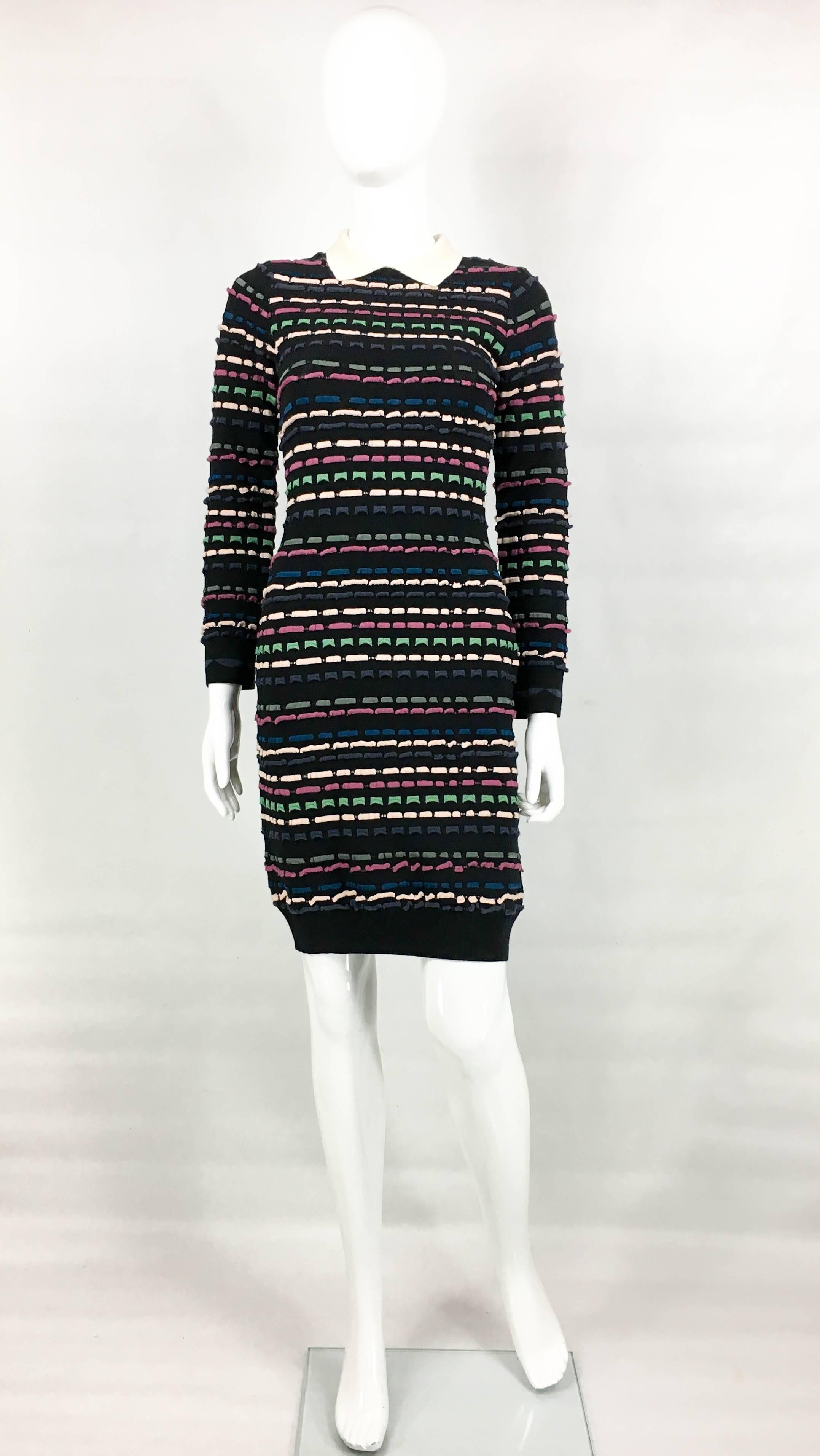 Missoni Multi-Coloured Striped Black Dress. This long-sleeve viscose-blend black dress has white polo collar. It features stripes of 3D colourful blocks throughout. A simple and fun dress to uplift the everyday wardrobe.

Label / Designer: