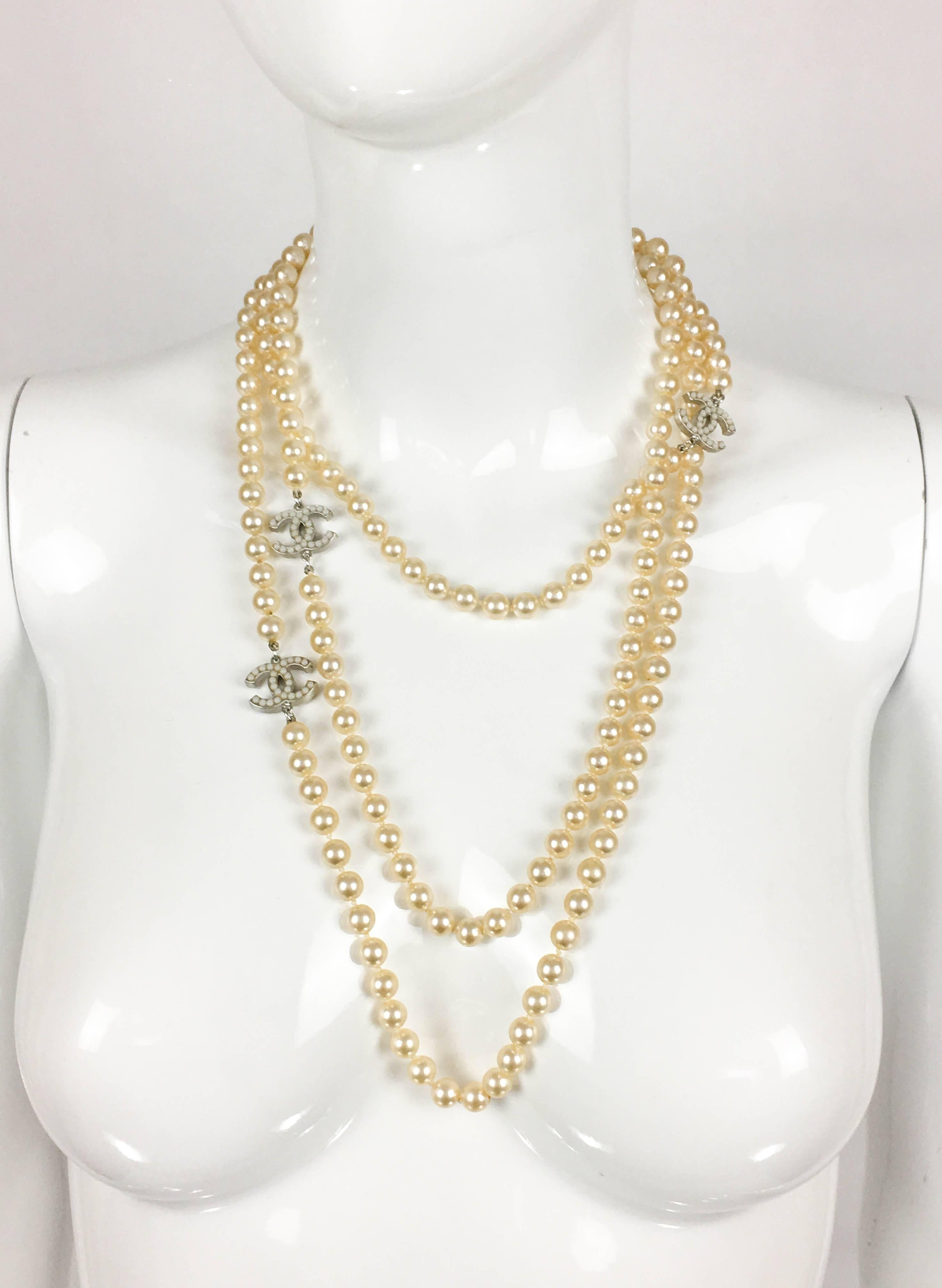 Chanel Long Pearl Sautoir with ‘CC’ Logo. This beautiful piece by Chanel dates from 2008. This very long faux pearl necklace features 3 white-metal pearl cabochon-embellished iconic ‘CC’ logos. Really versatile, this sautoir necklace can be worn as