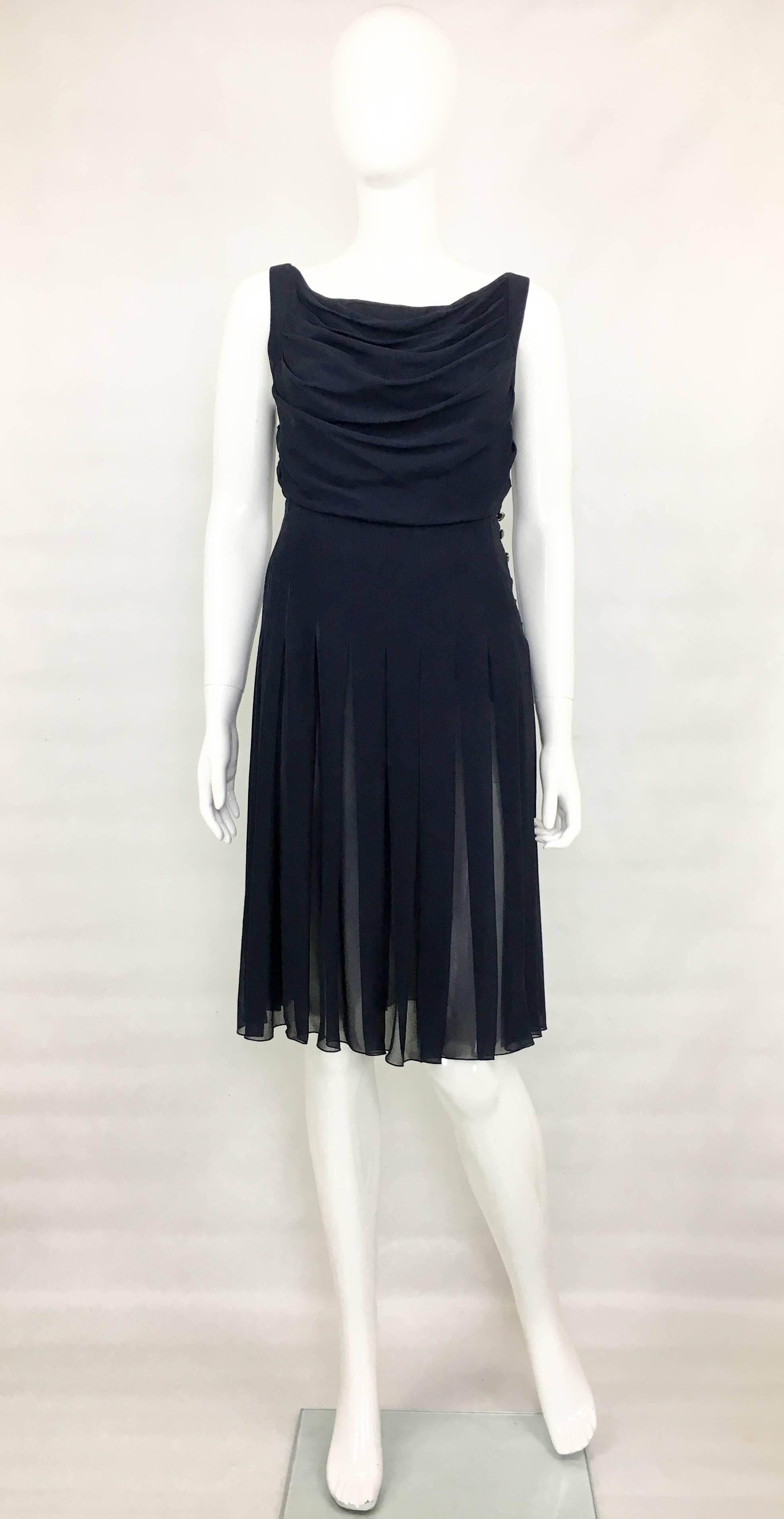 Vintage Chanel Midnight Blue Silk Chiffon Dress. This chic sleeveless dress by Chanel is part of the 2000 Spring / Summer Collection. In midnight blue silk chiffon, it has a draped bust and pleats to the skirt. It is self-lined and it has an