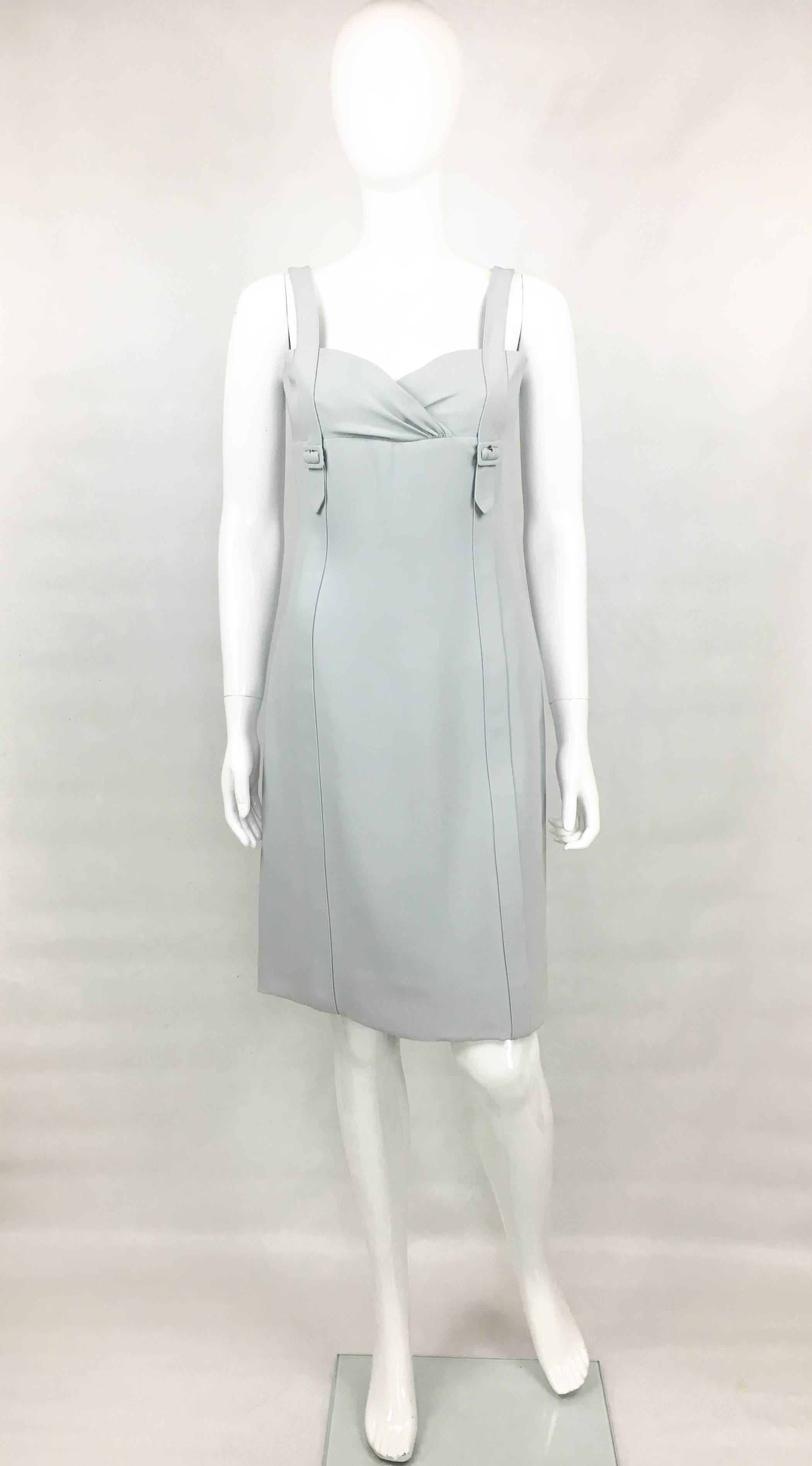 Valentino Pale Blue Silk Dress. This elegant dress by Valentino is made, and lined, in pure silk. Knee-length, it features belt-style straps and draping to the bust. It closes with an invisible zipper on the back. A chic and versatile dress that can