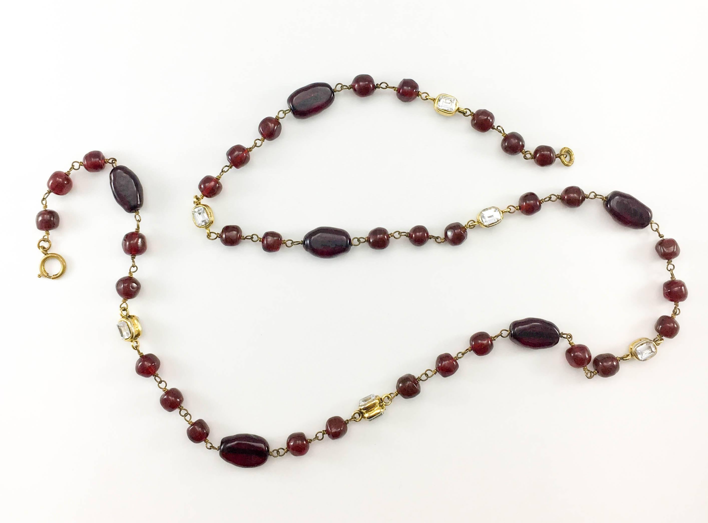 Vintage Chanel Red Gripoix Necklace. This beautiful necklace by Chanel was crafted in the 1970’s. The design consists of organically shaped red gripoix beads and rectangular crystals in gilt settings. Versatile, it can be worn as a long necklace or