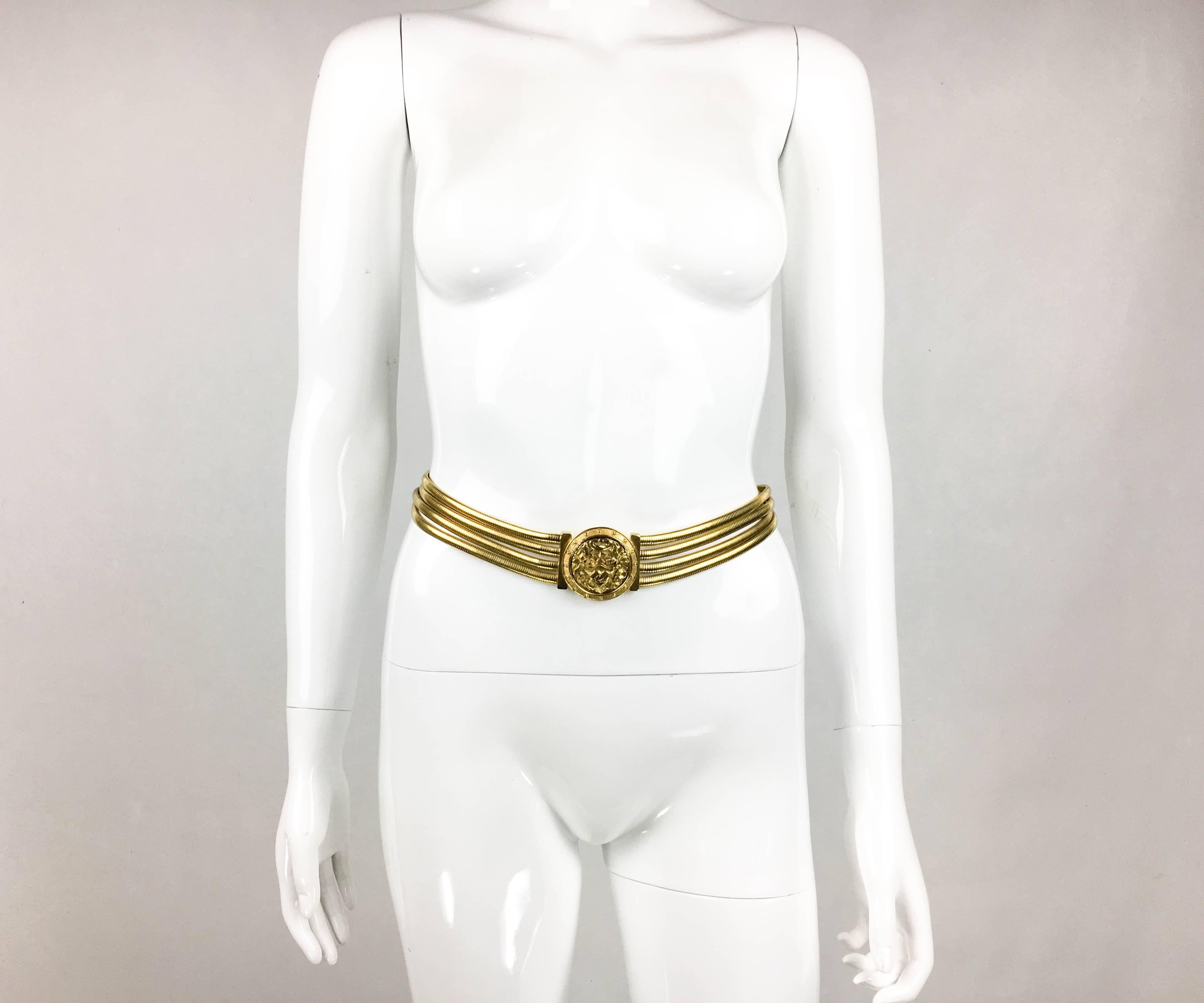 Vintage Christian Lacroix Gilded Belt. This gorgeous belt by Lacroix dates back from the late 1980’s. Made in gilt metal, it features 4 snake chains as the body of the belt. The buckle is medallion-style with intricate design. Packed with glamour