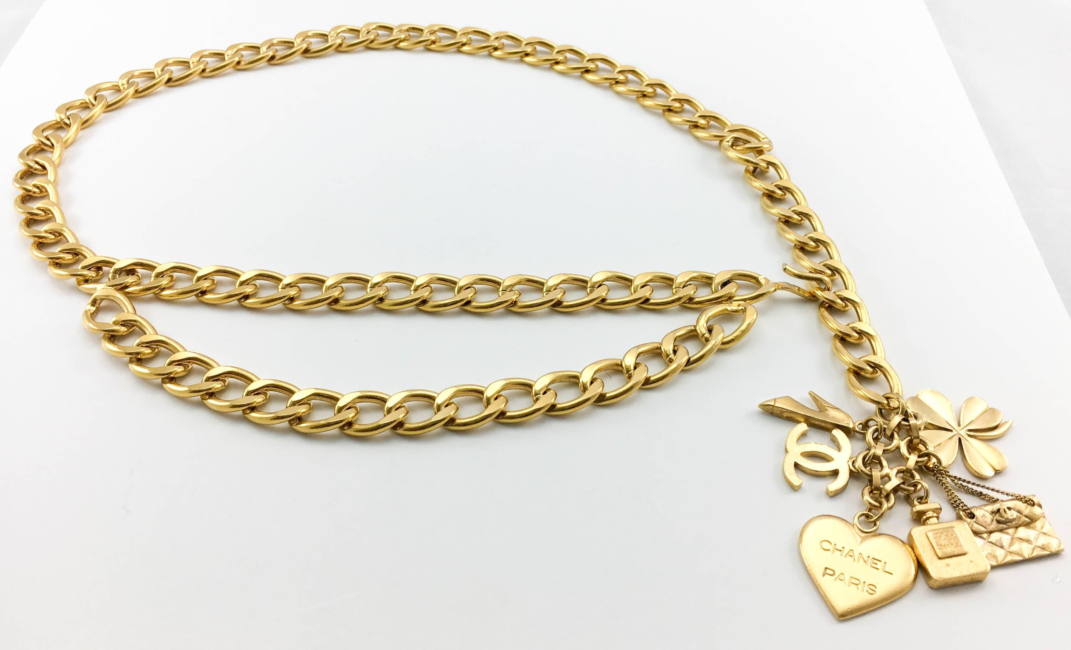 Vintage Chanel Gilt Chain With Charms Belt. This fabulous belt by Chanel was created for the 1996 Spring / Summer Collection. It is made in a chunky gilt metal chain with a 2-tier design on the front. The main feature, however, must be the charms at
