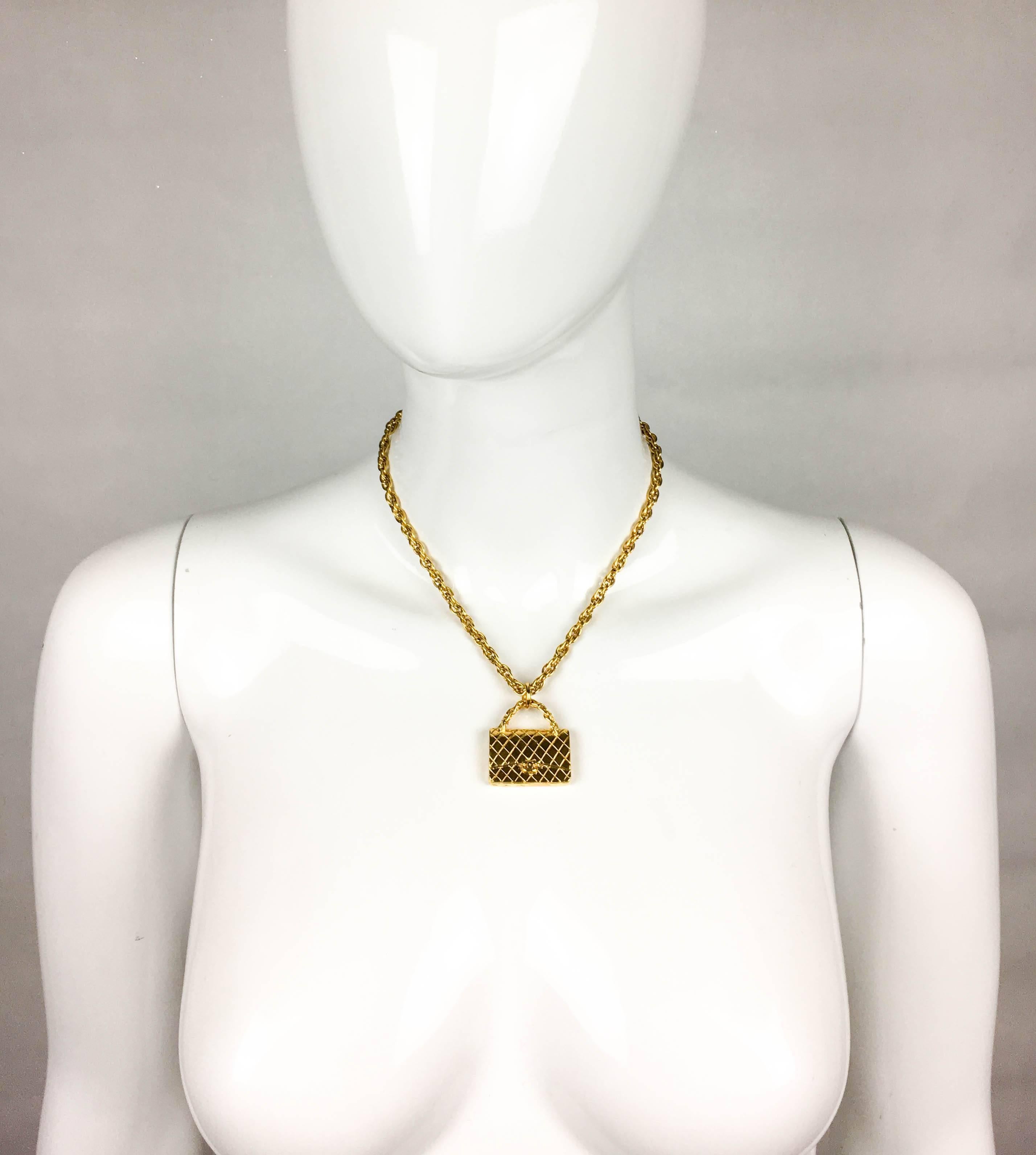 Vintage Chanel Gold-Plated Pendant Necklace. This stylish piece by Chanel features the iconic 2.55 handbag as a gold-plated pendant on a chain. Chanel 94 A signed on the back. The perfect way to add a dash of glamour to any look. 

Label / Designer: