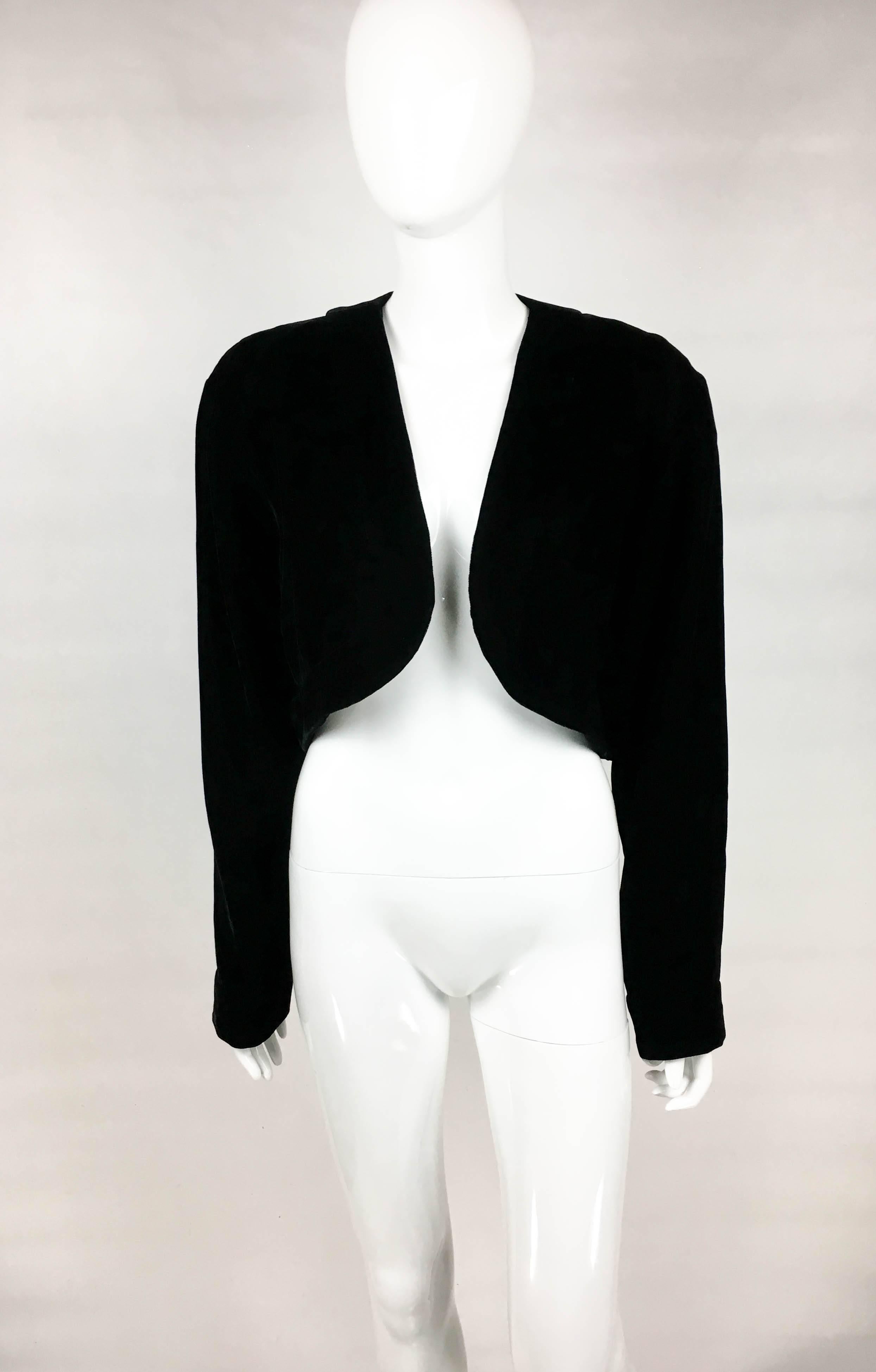 Vintage Lanvin Black Velvet Bolero Jacket. This stylish piece by Lanvin dates back from the 1990’s. Made in black velvet, this elegant jacket features clean, simple lines and no closure to the front. Lined. 

Label / Designer: Lanvin

Period: