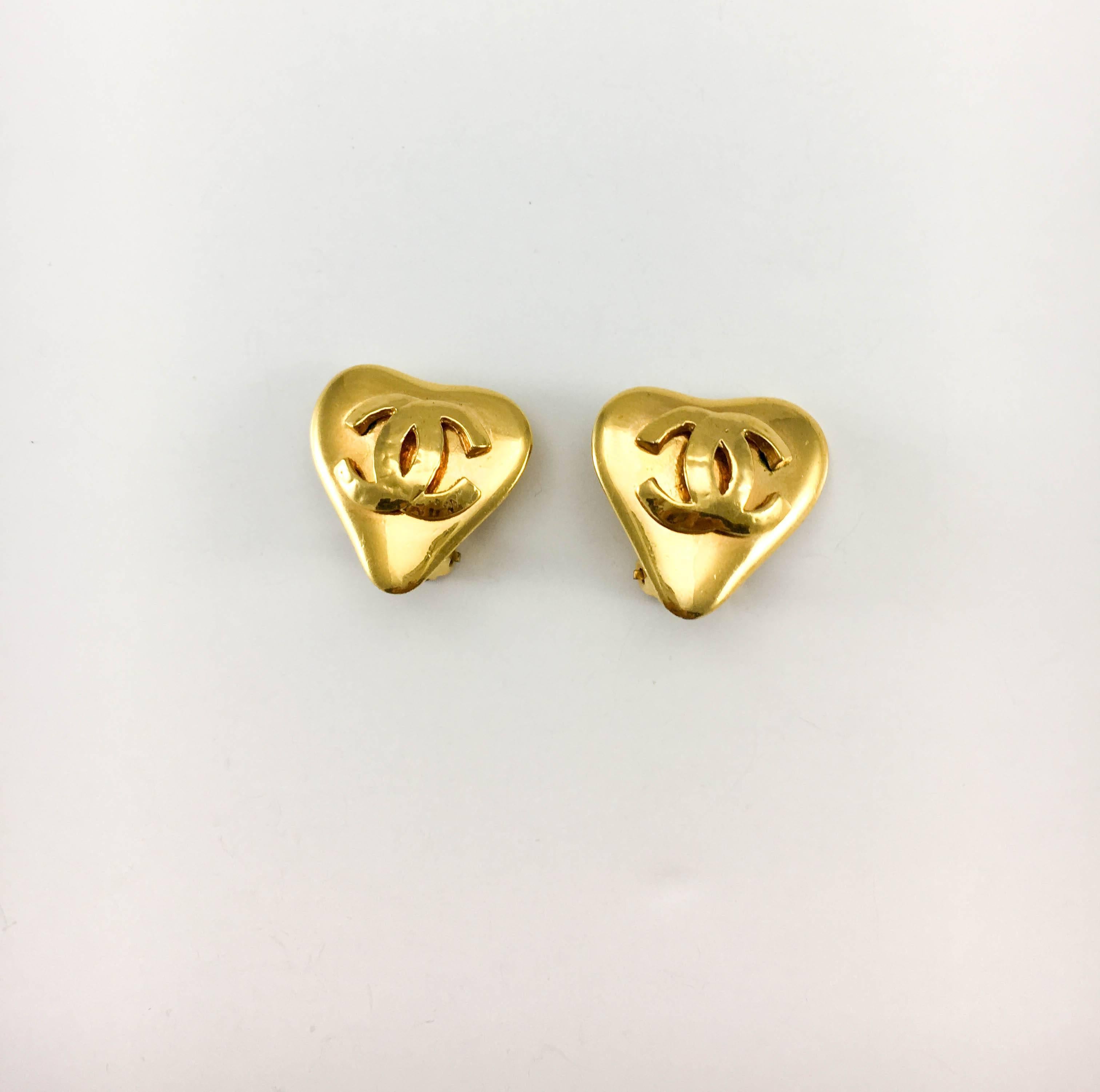 Vintage Chanel Heart-Shaped Gold-Plated Logo Clip-On Earrings. These very cute earrings by Chanel were created for the 1993 Spring / Summer collection. Gold-Plated, they are in the shape of a heart and feature the iconic ‘CC’ logo in the centre. A