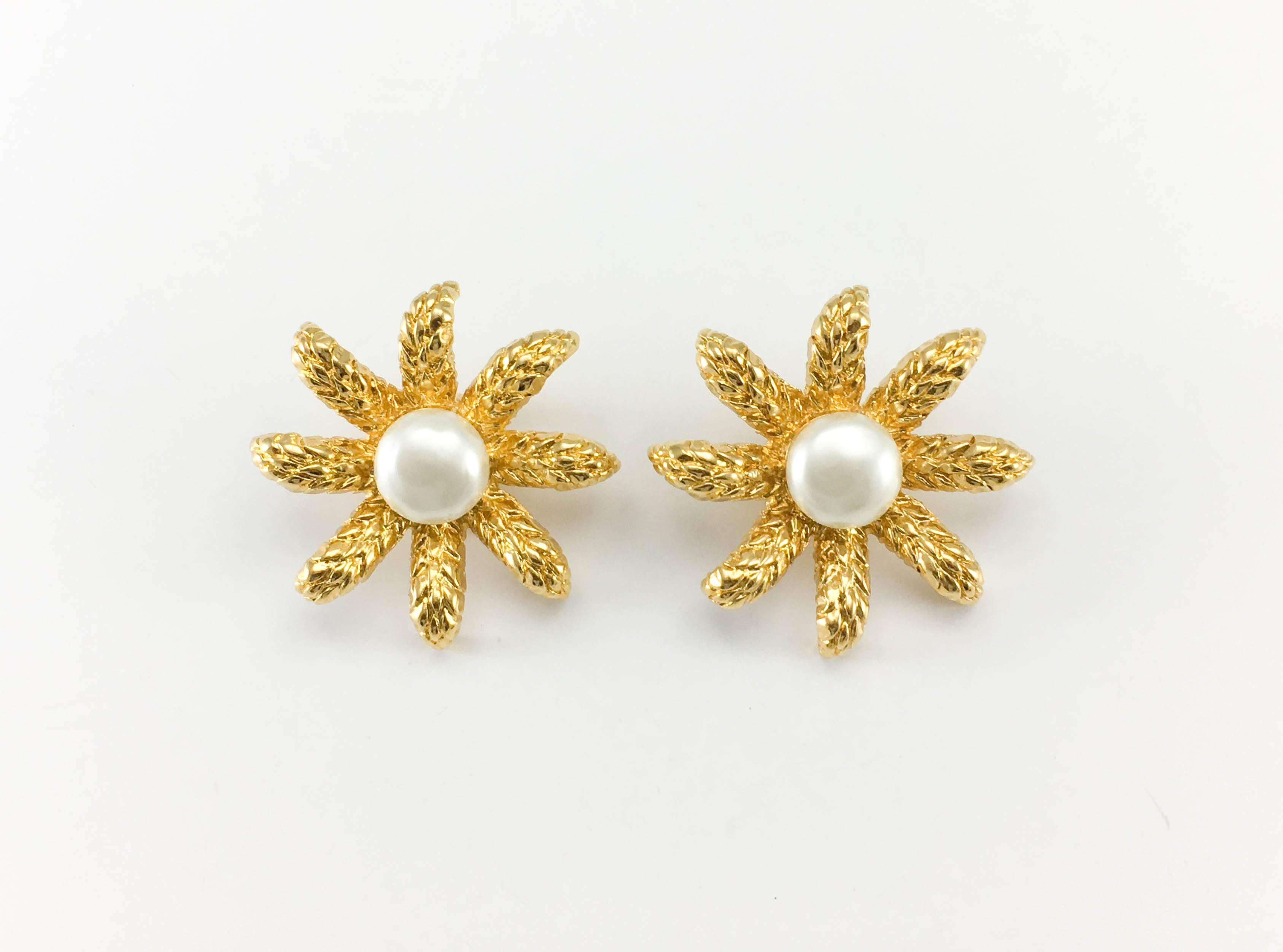Vintage Chanel Faux Pearl Flower Clip-On Earrings. Made for the 1994 Autumn / Winter collection, these beautiful earrings by Chanel are made in gold-plated metal. In the shape of a flower with long, thin petals, they have a faux pearl cabochon in