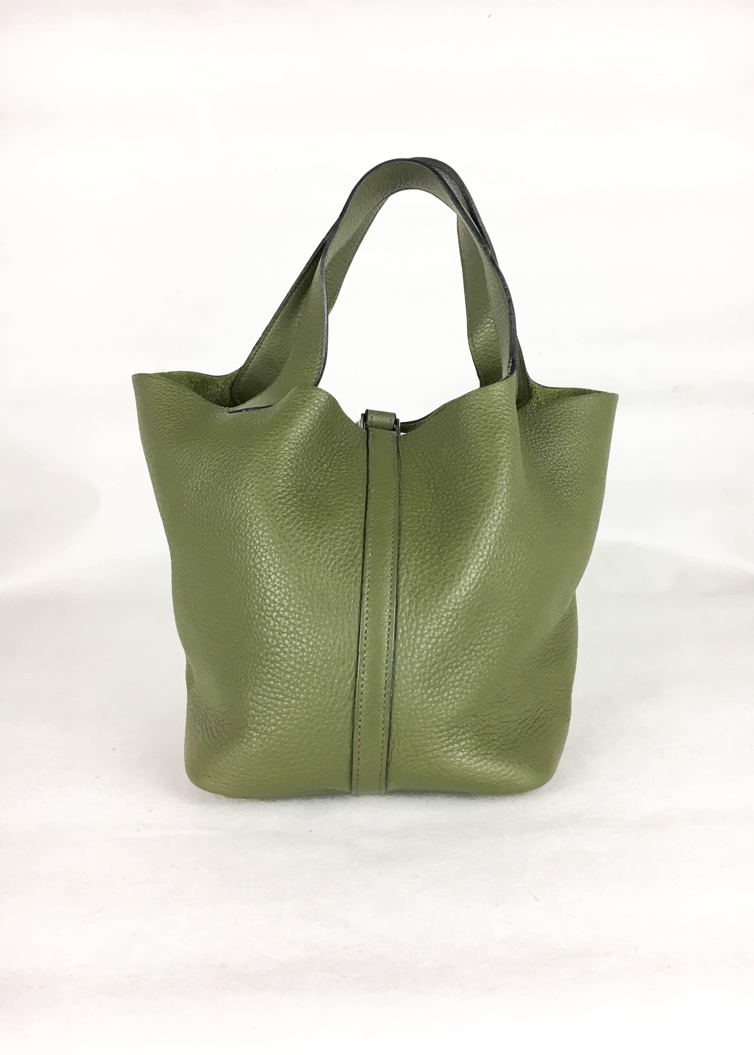 Gorgeous Hermes Picotin Handbag. In olive green clemence leather and palladium hardware, this is a very stylish handbag by Hermes. Green suede on the inside. Hermes signed, date code ‘K’ in a square (2007). An understated piece of luxury by the