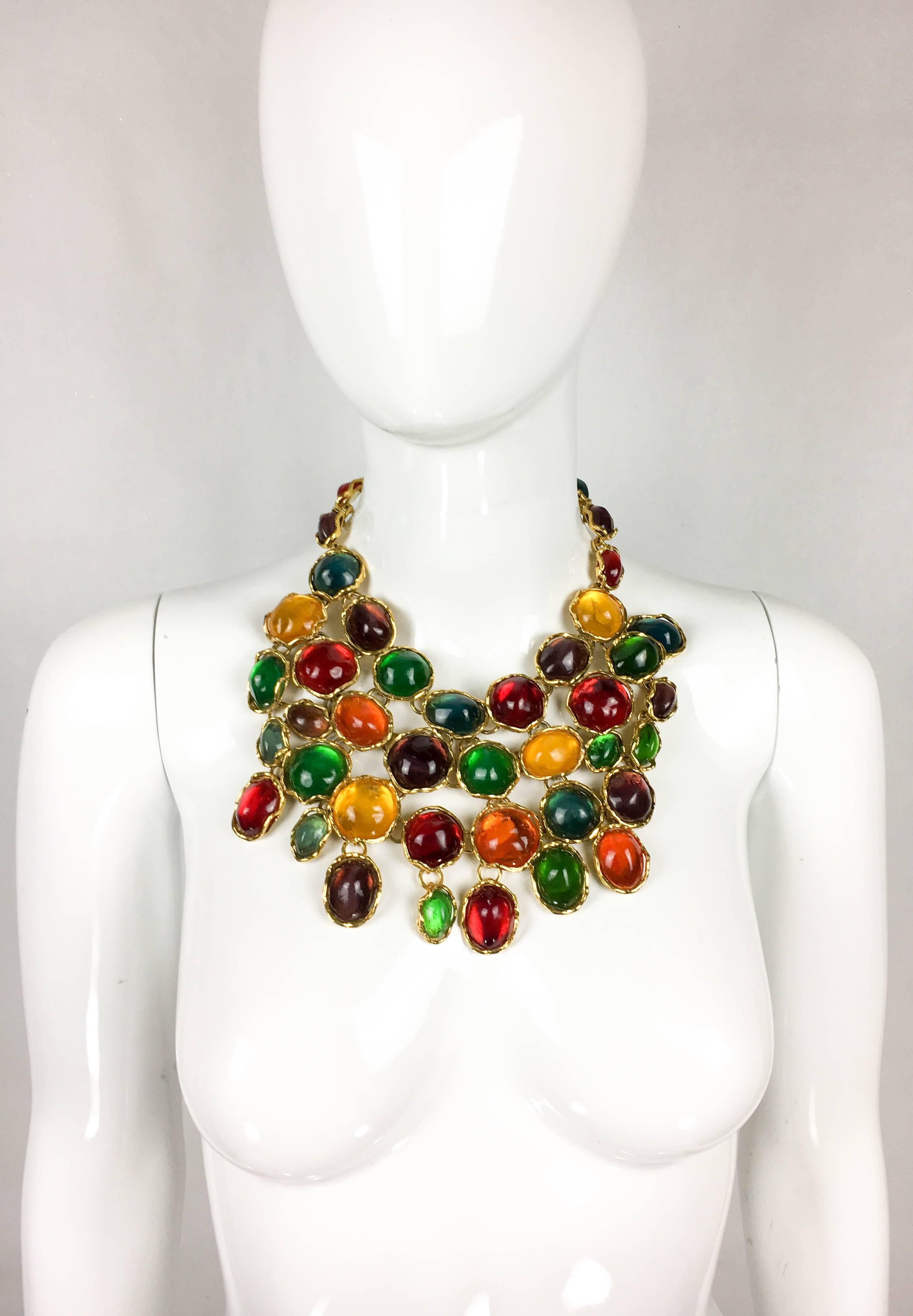 Vintage Yves Saint Laurent Colourful Resin Bib Necklace. This amazing piece by Yves Saint Laurent dates back from 1990. Set in gilt metal are irregular resin gems in various sizes and colours creating a dramatic bib. S-Hook closure on the back.